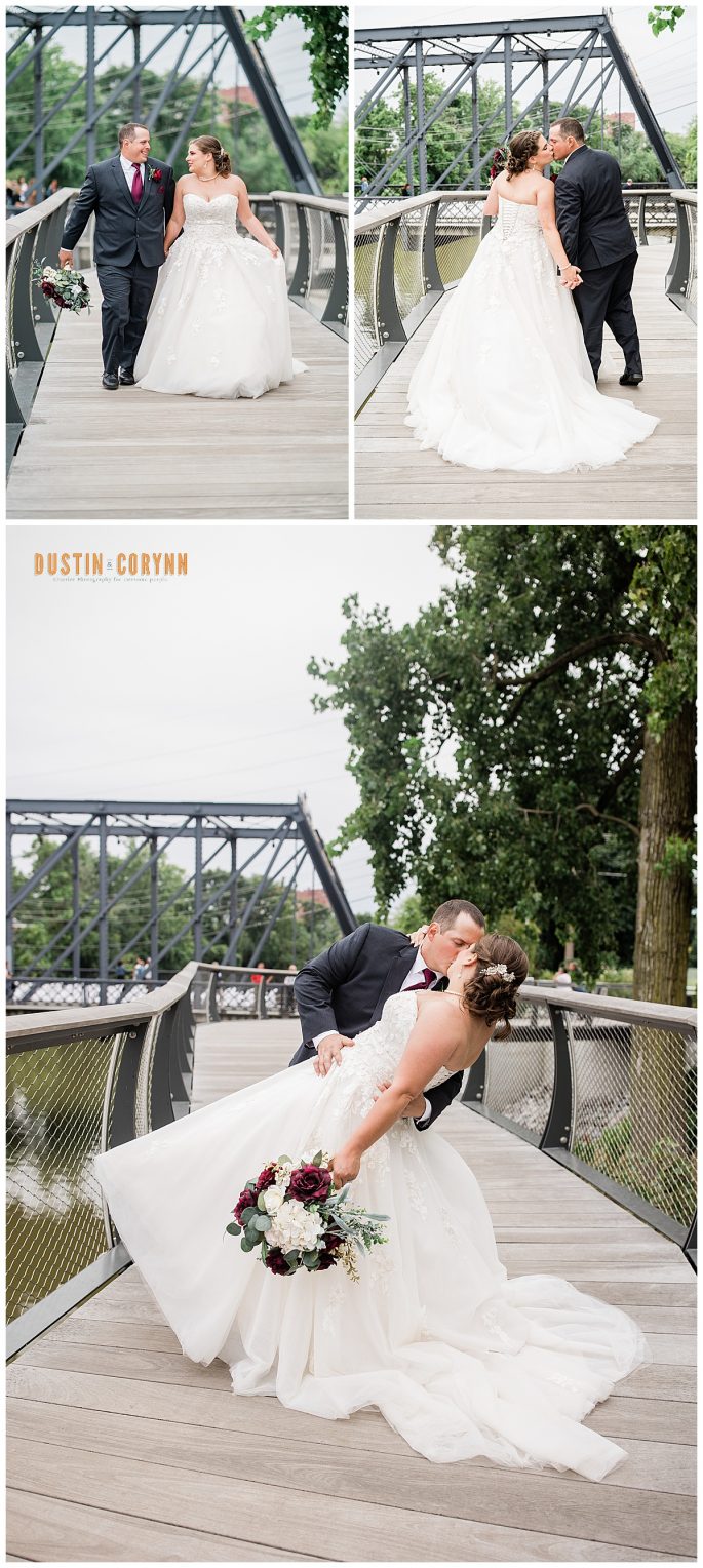 Fort Wayne wedding photographers capture bride and groom kissing in front of bridge