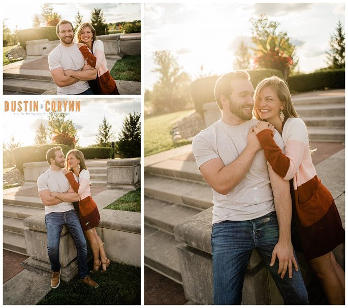 sun setting behind man and woman at Coxhall Gardens during their engagement session as they smile at each other 