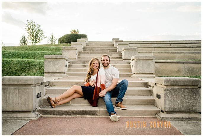 couple sitting on stairs at a garden in Fort Wayne for their engagement photos