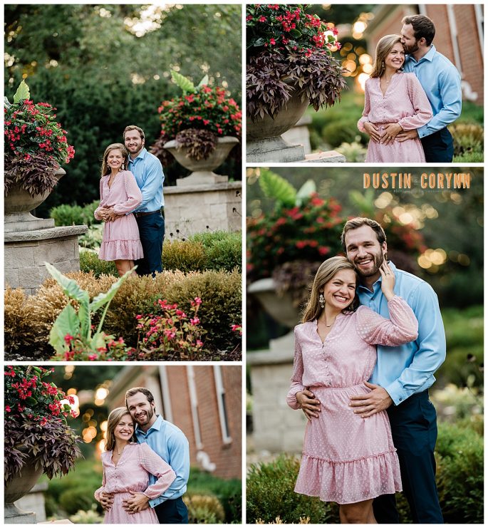 woman in pink dress holding man in blue button down in a beautiful garden in the summer