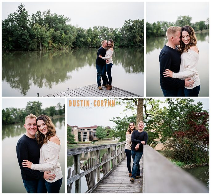 lake engagement session with man in black sweater and woman in white sweater as they stand on a dock together smiling