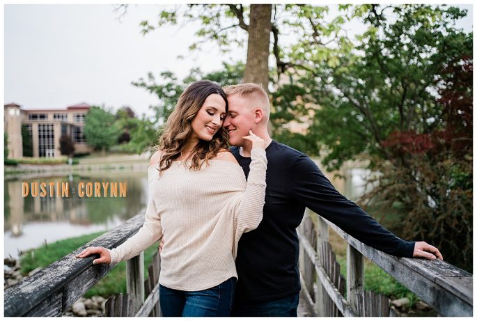 woman and man on a bridge on the water at Saint Francis Indiana for their engagement session