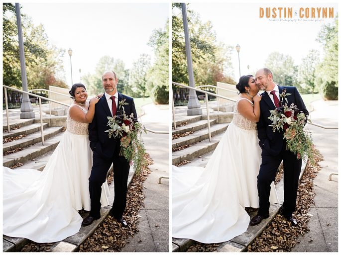 downtown bridal portraits of bride and groom standing on stairs in the city as the couple kisses each other on the cheek