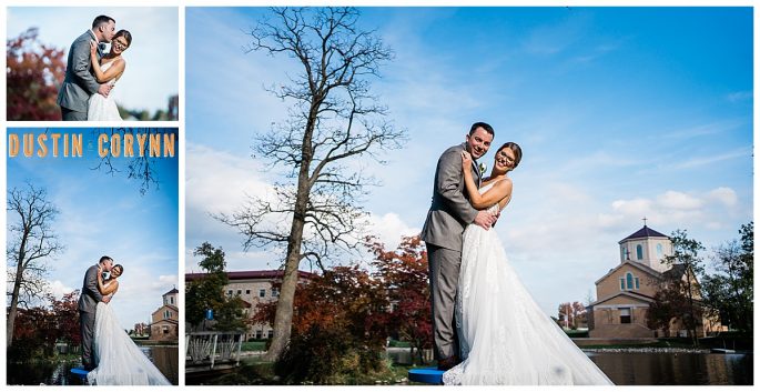 church bridals with bride and groom embracing and smiling at the camera with bright blue skies behind them and a church in the distance