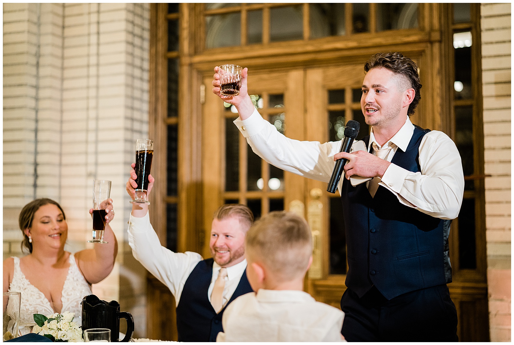 groomsmen giving toast during reception