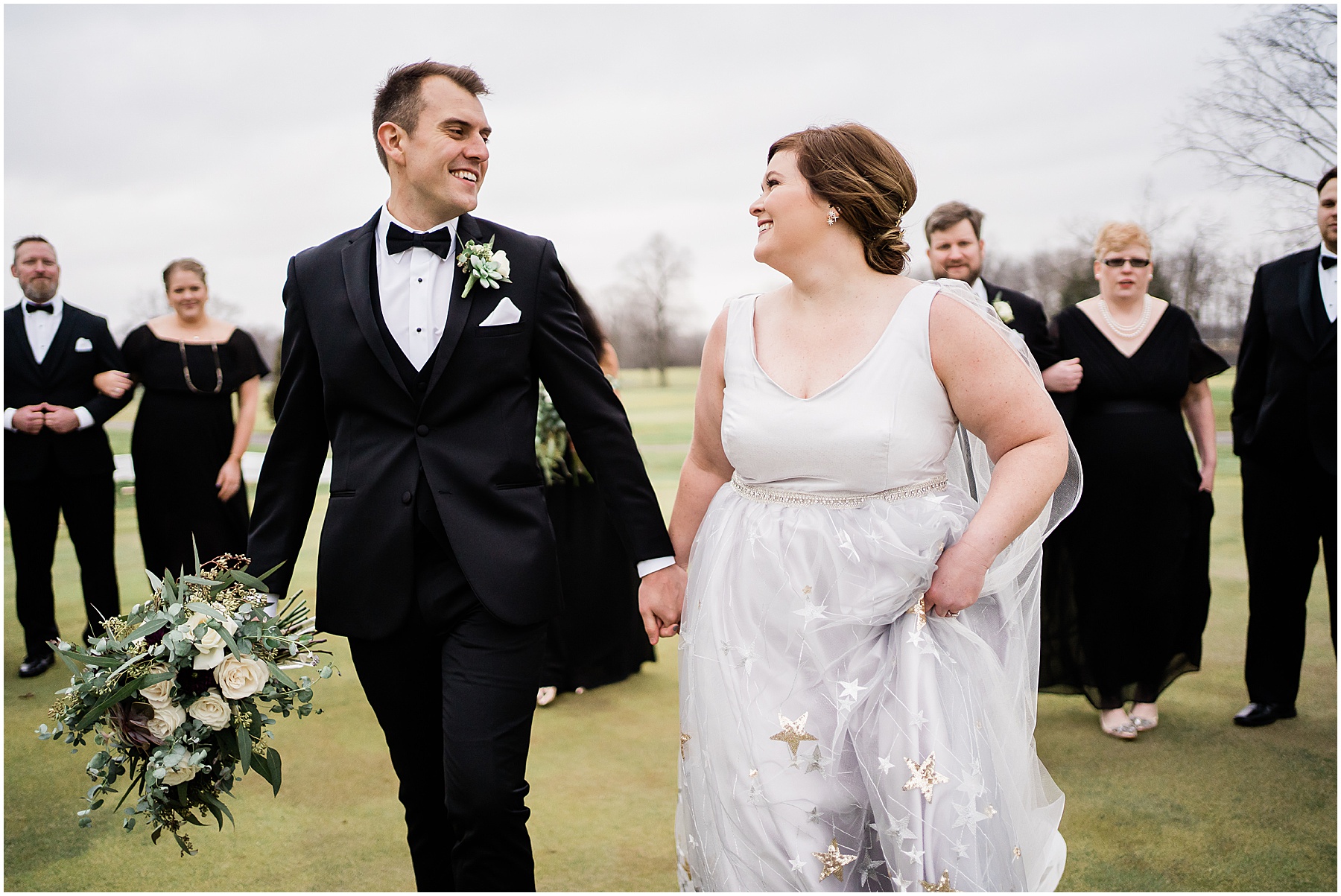 bride and groom walking hand in hand 