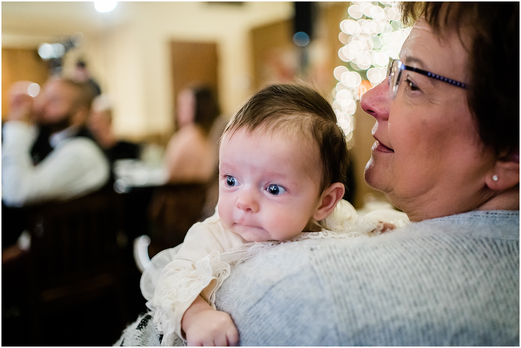 guest holding baby during new year's eve wedding reception