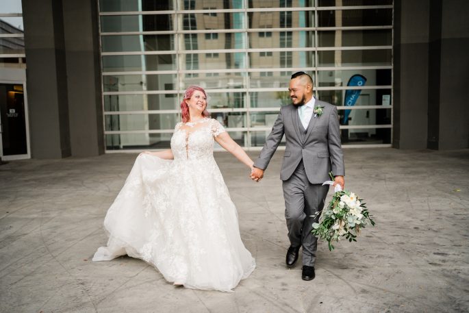 bride and groom walking after wedding with florals from florists in indianapolis