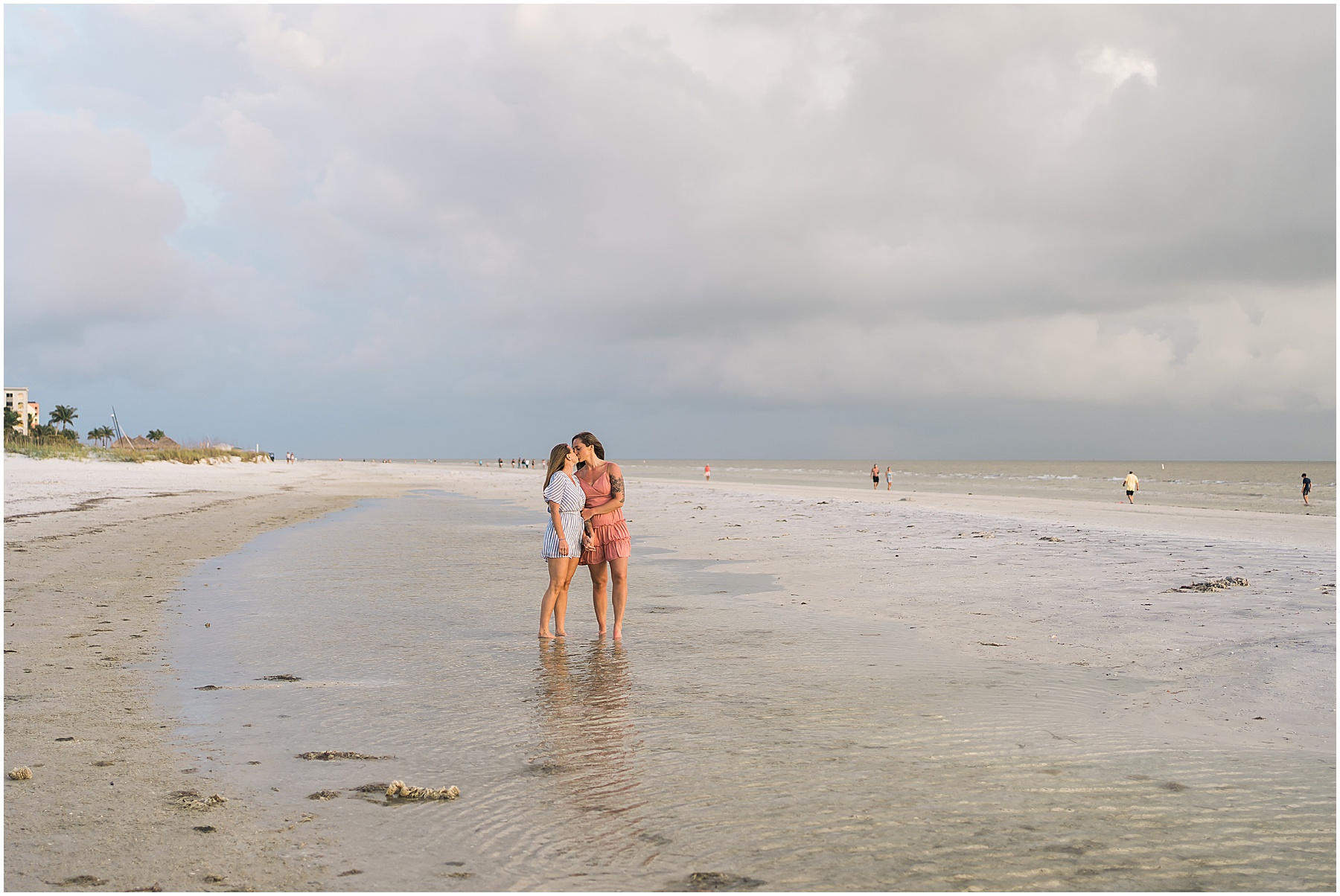 engaged couple kissing in the water during beach engagement session