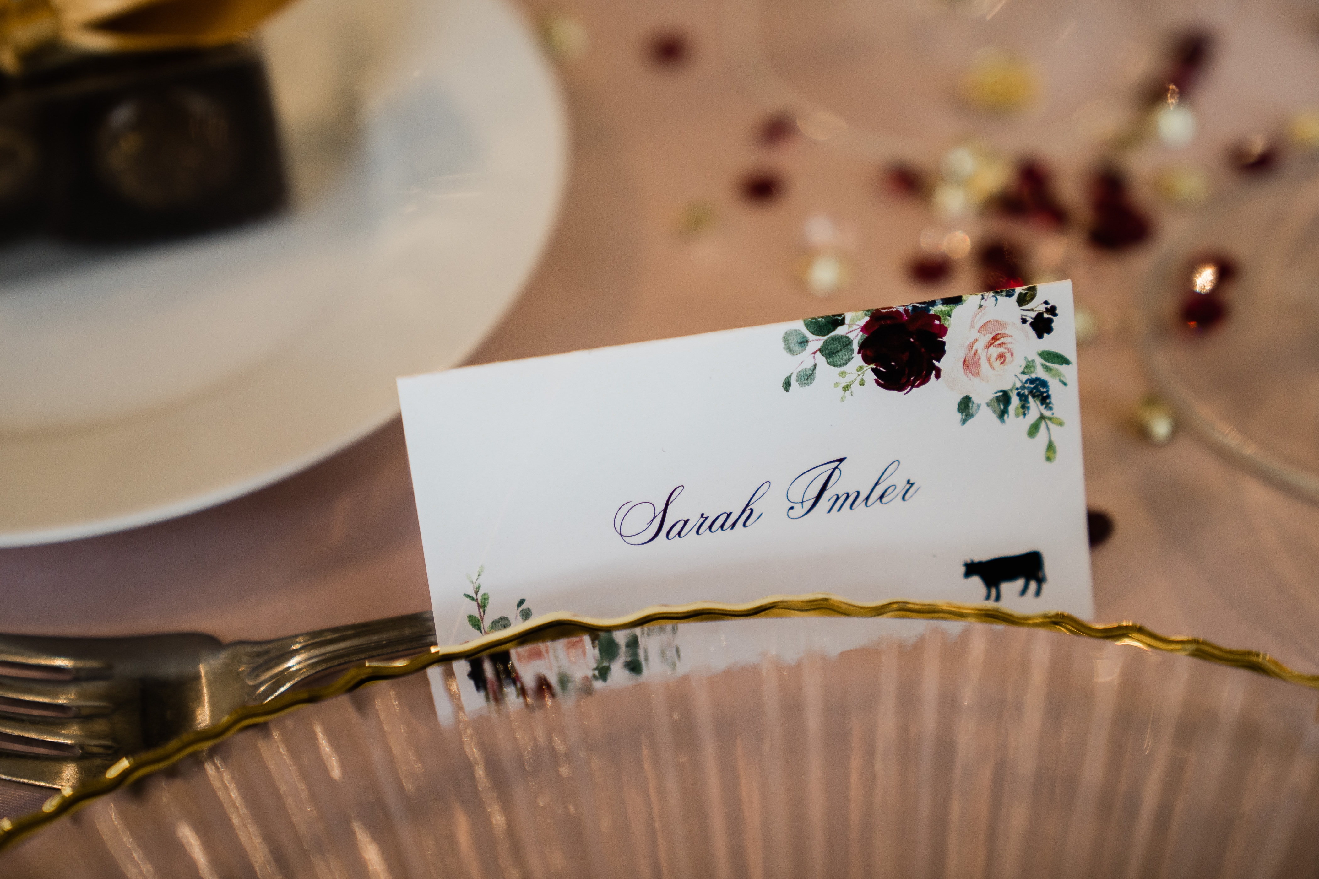 reception table name cards with little burgundy roses and light pink florals