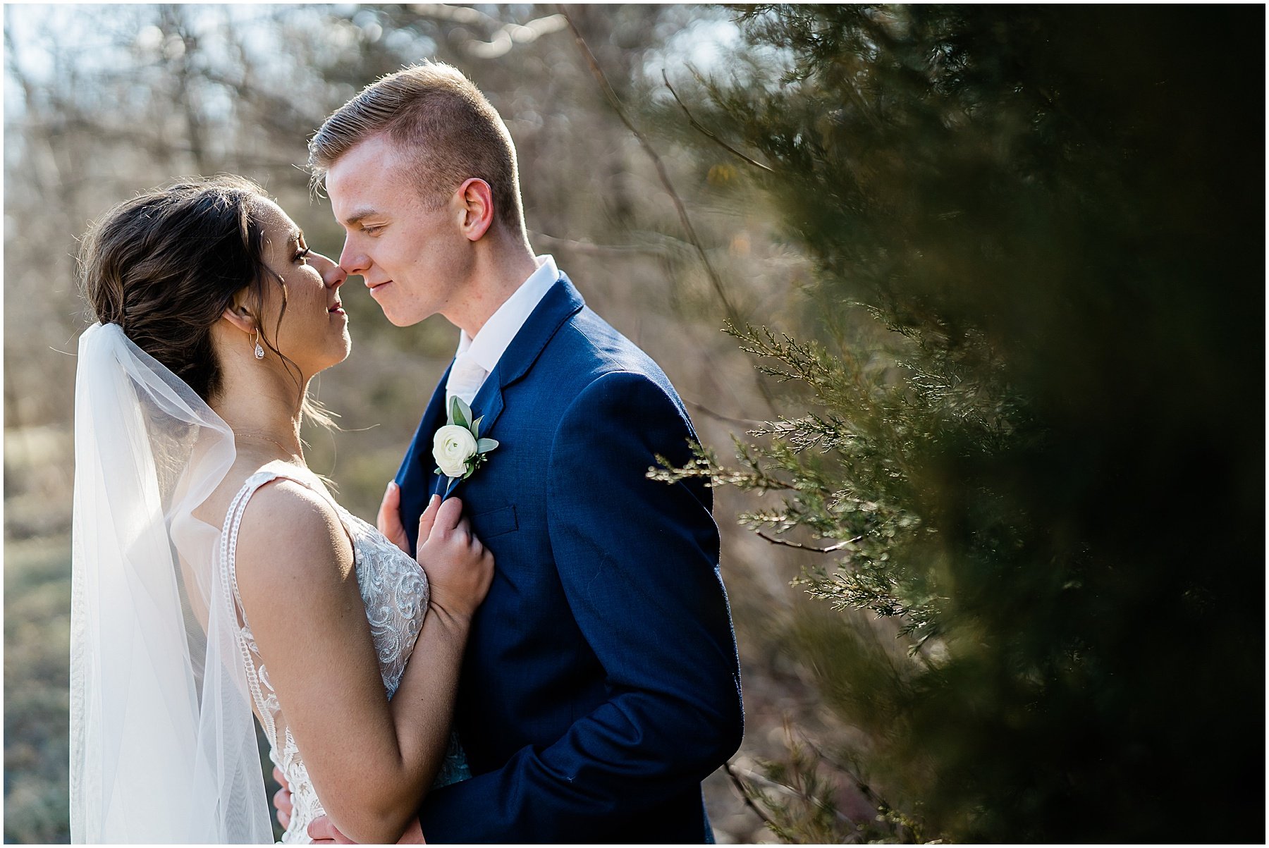 wedding couple embracing during outdoor portraits