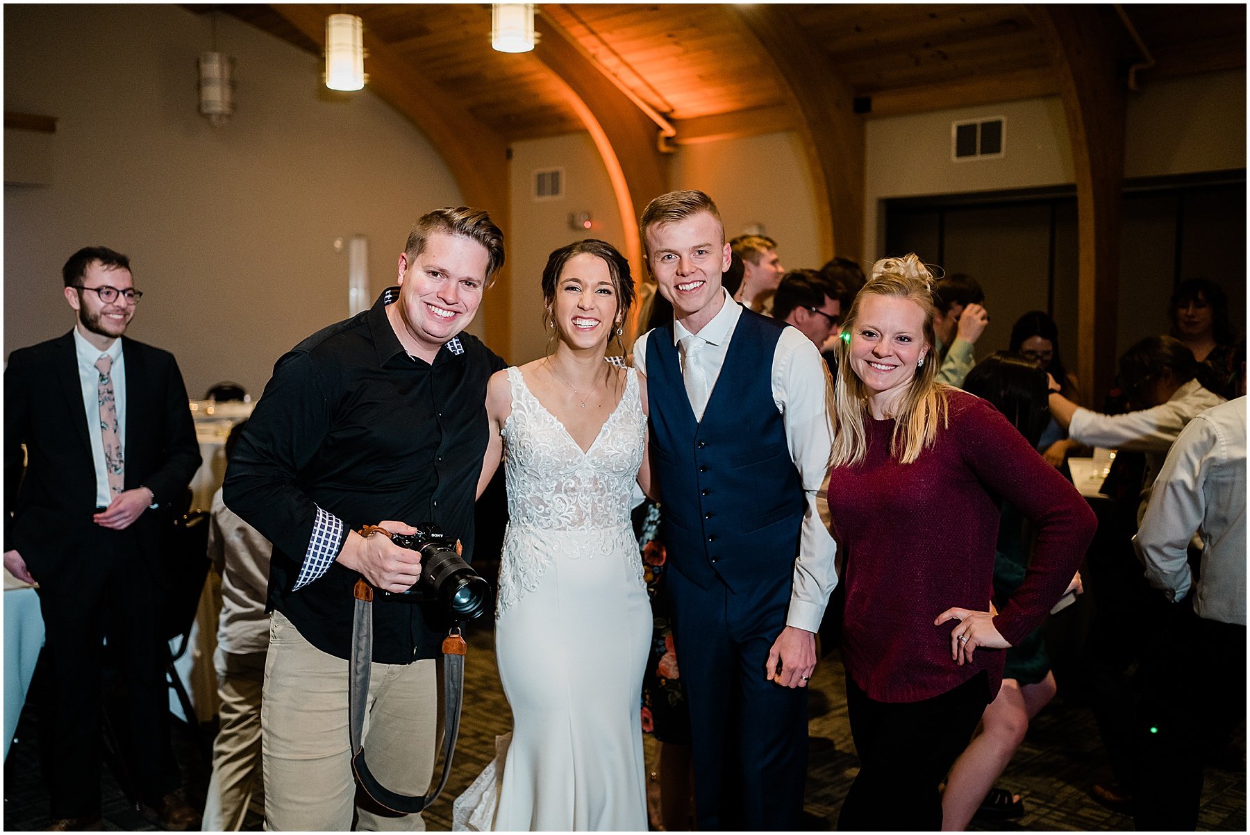 couple posing with Dustin and Corynn photography team at indiana wedding
