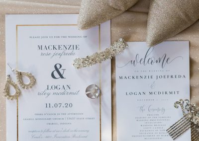 wedding invitation, bridal jewelry and wedding perfume laid out for a wedding flatlay