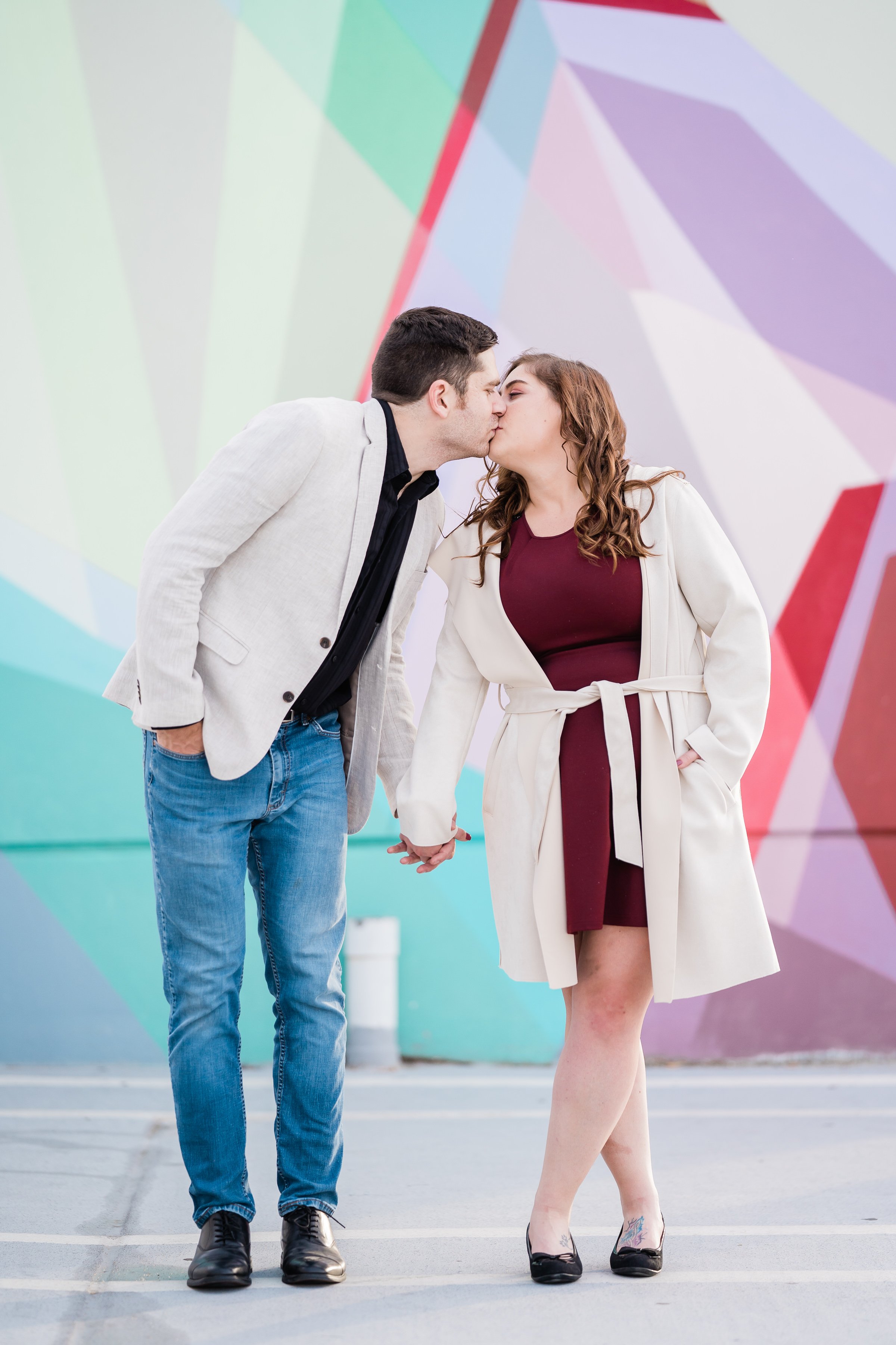 Fort Wayne wedding photographers capture engaged couple in front of an art mural downtown