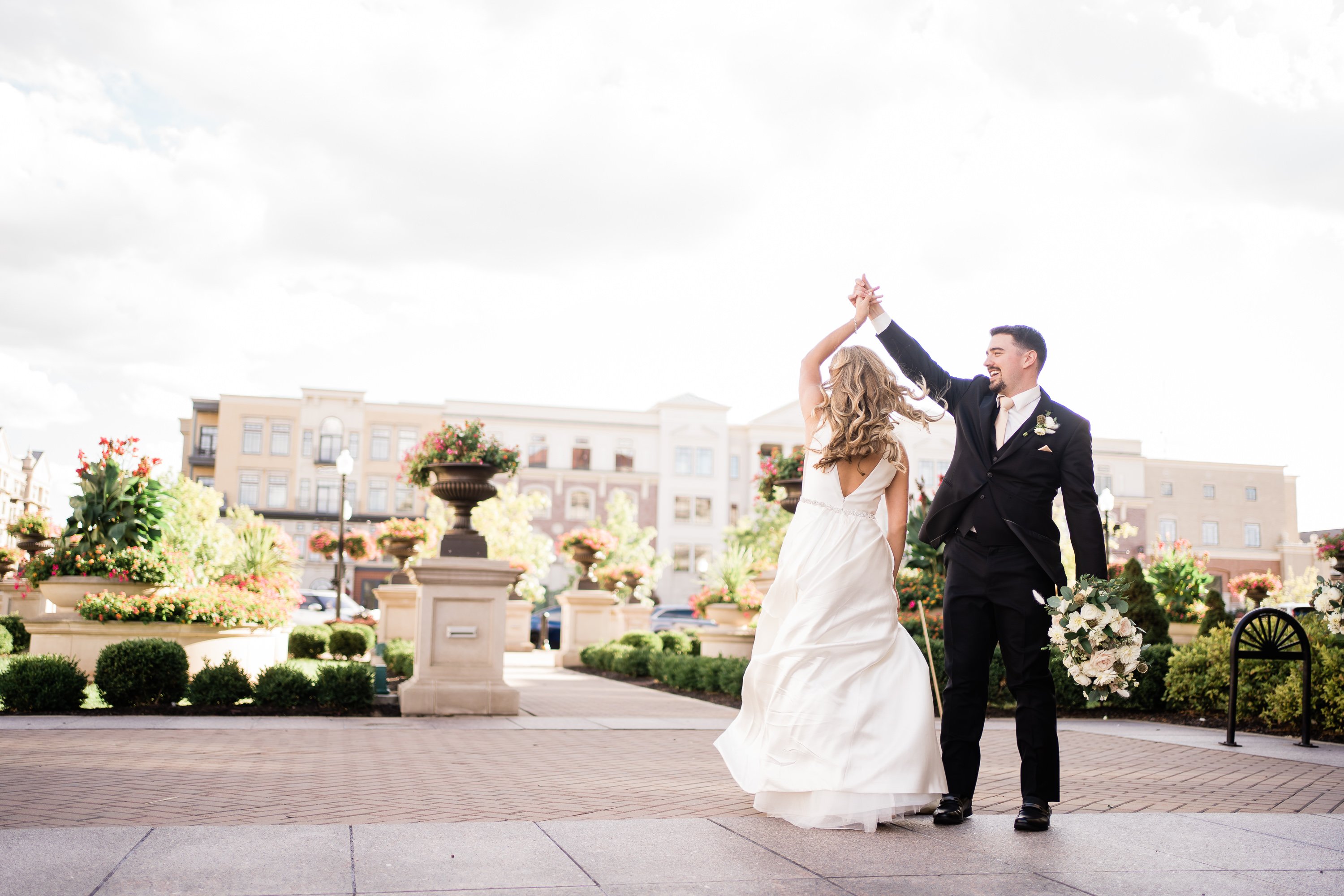 first dance for Fort Wayne wedding with groom twirling his bride outside of their wedding venue