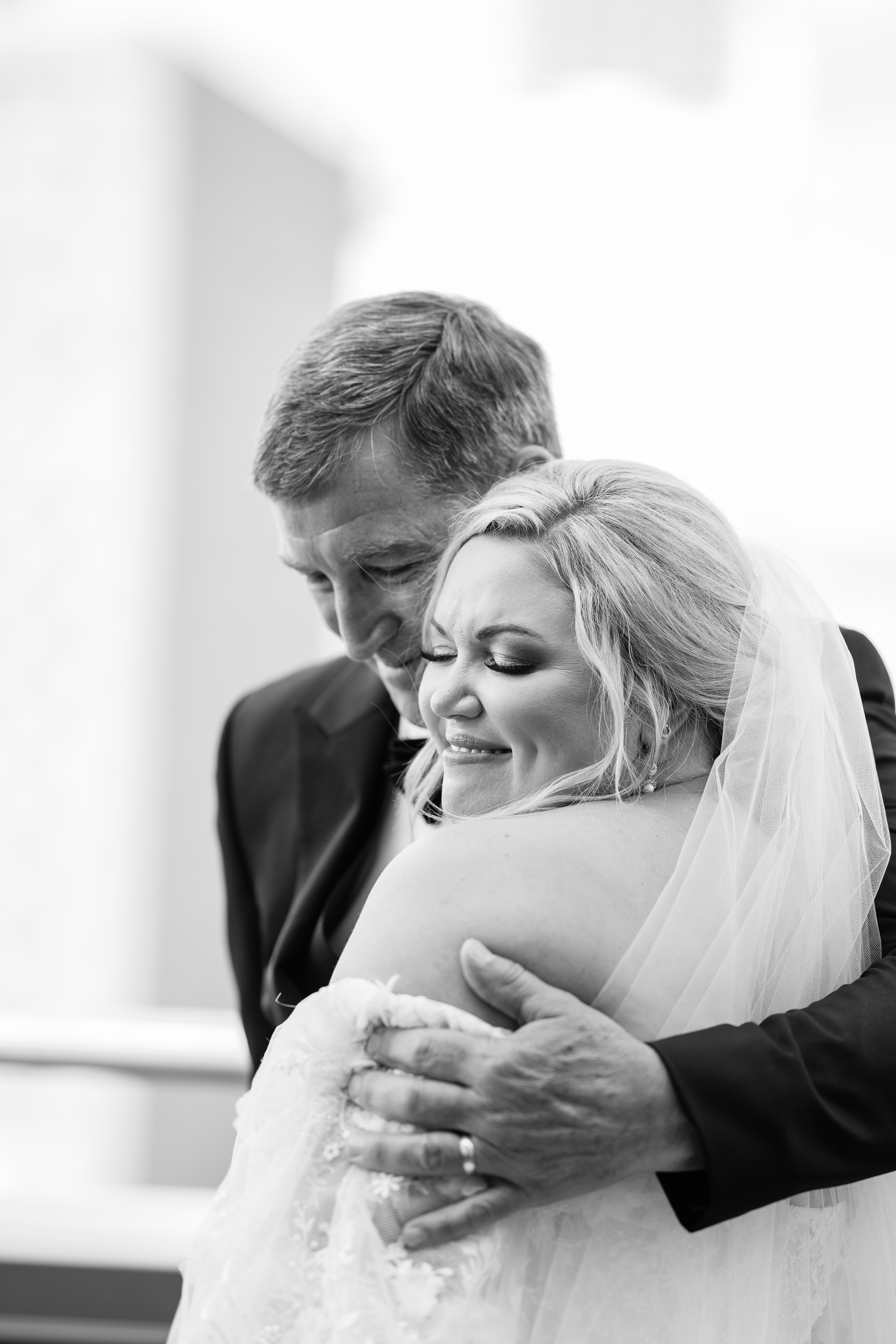 bride and her father hugging before the wedding ceremony