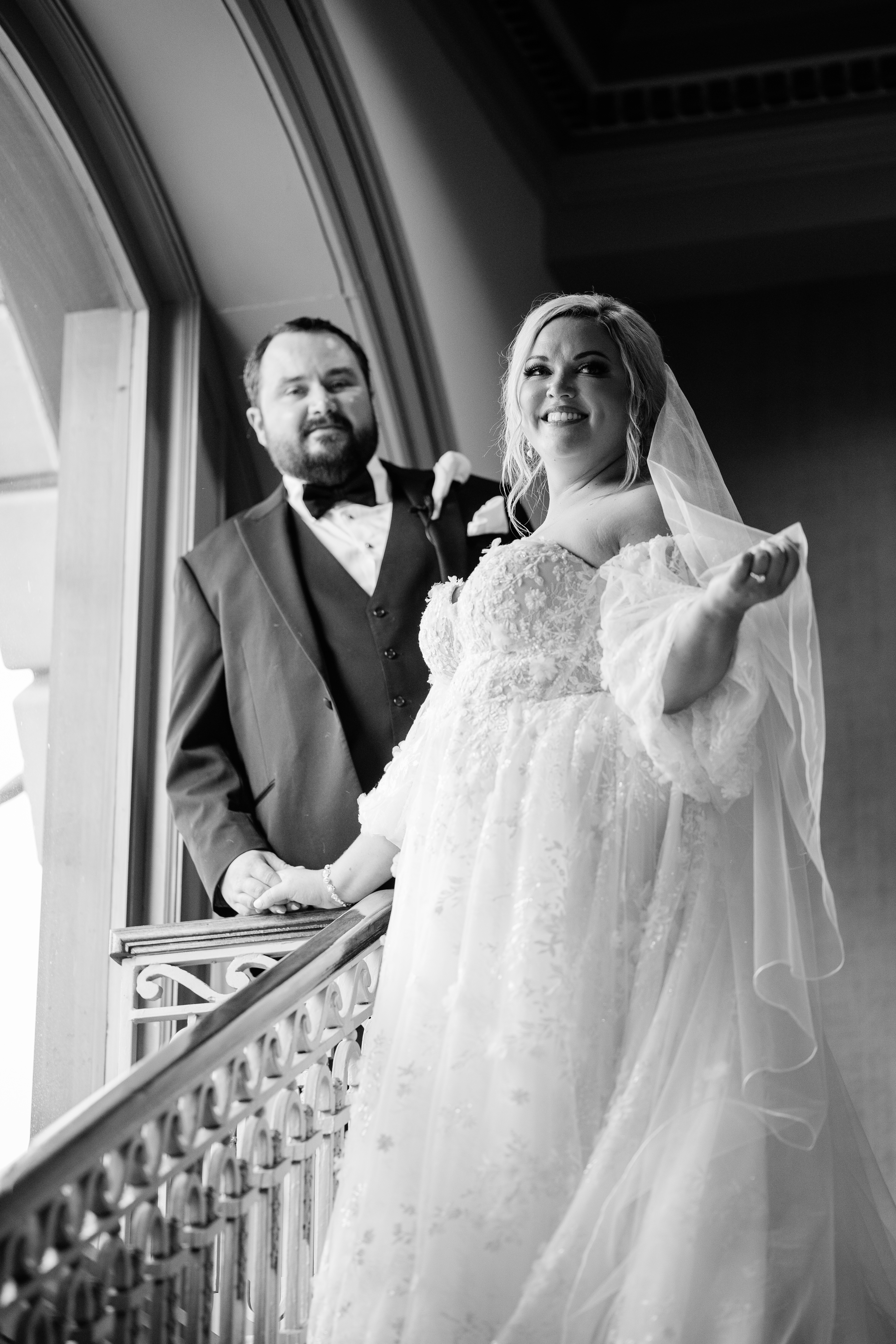 bride and groom on a staircase together for their wedding pictures by Fort Wayne wedding photographers