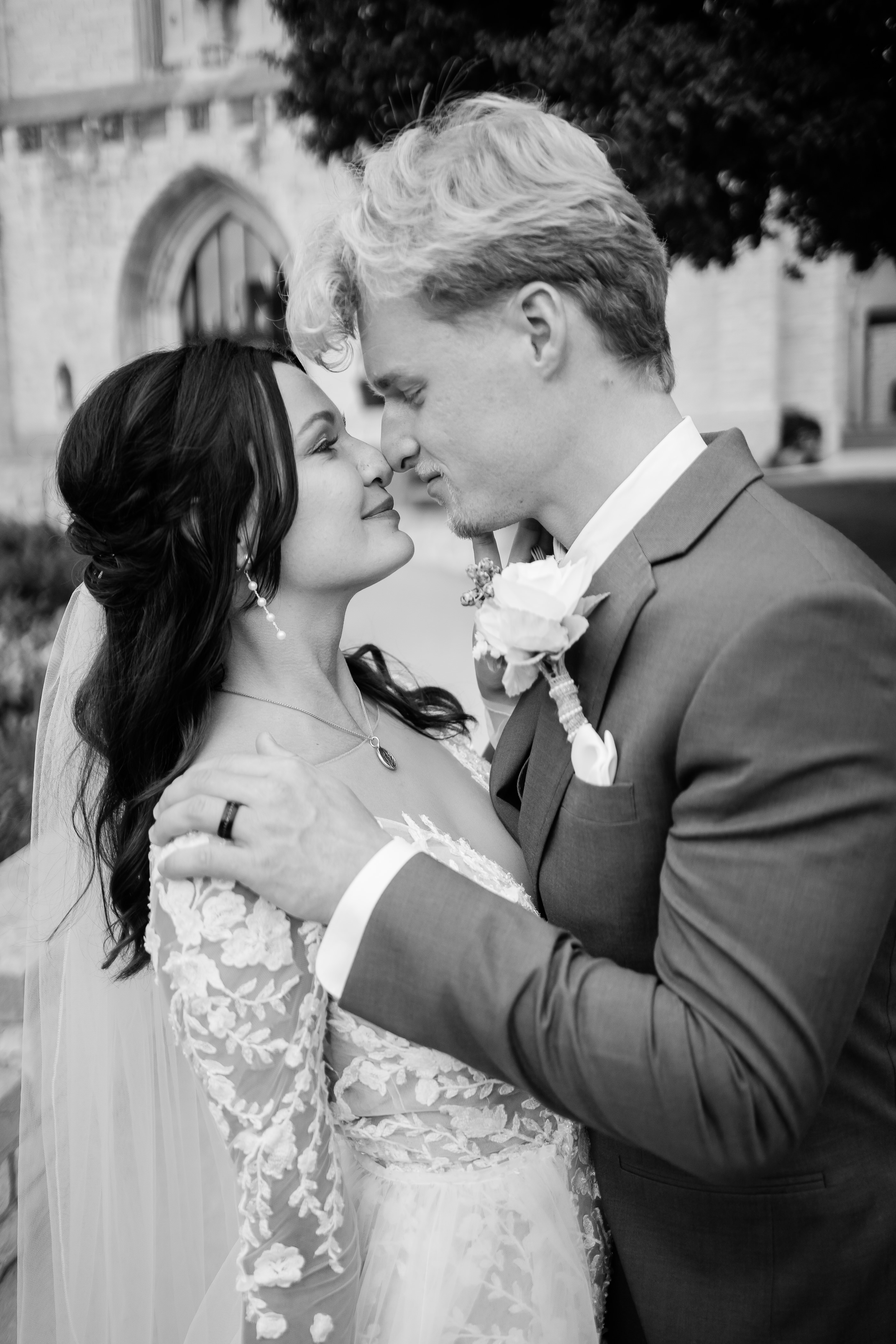black and white romanic wedding photo of bride and groom embracing and touching their noses together captured by Fort Wayne wedding photographers
