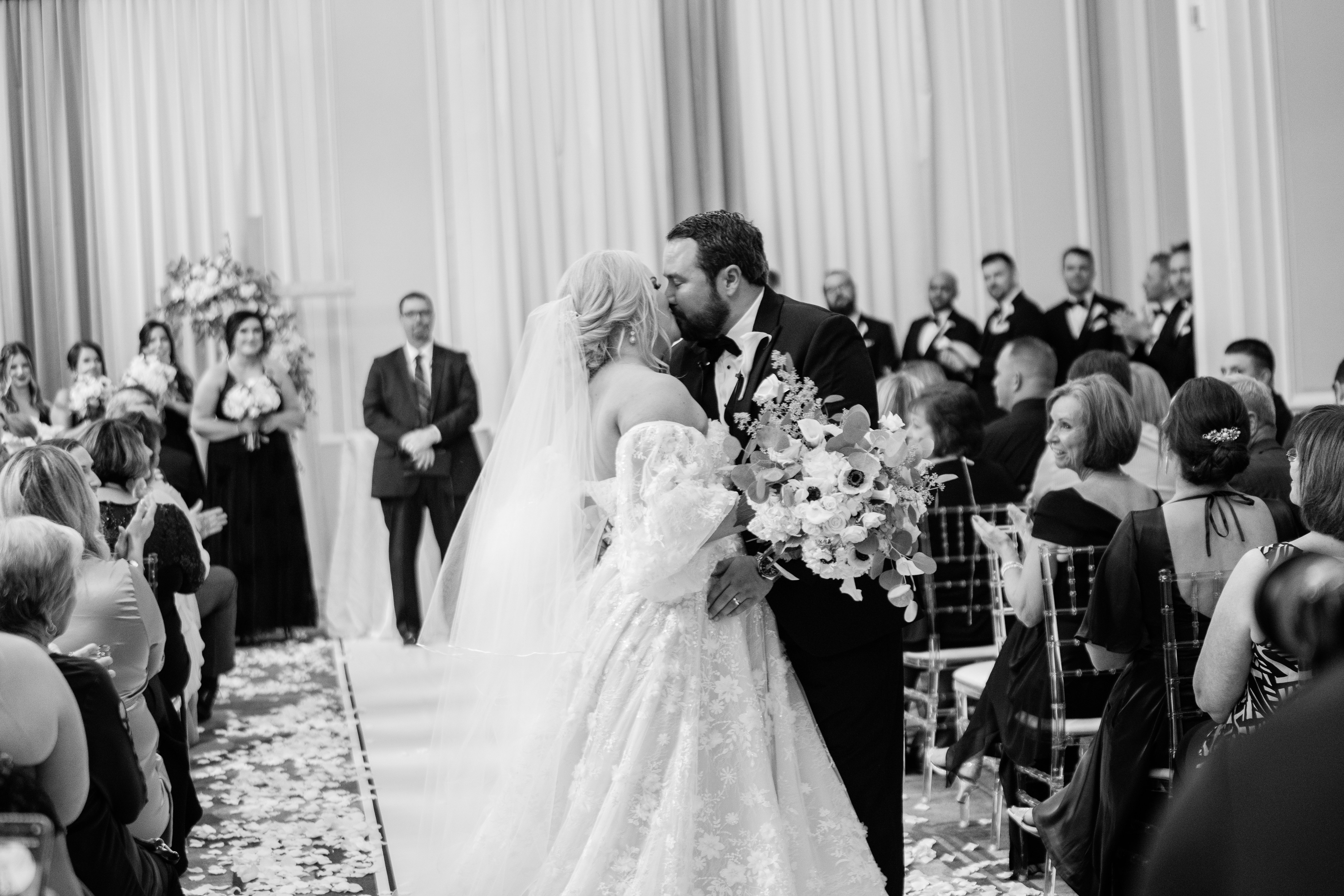 bride and groom kissing at the end of their wedding cermeony taken by Fort Wayne wedding photographers