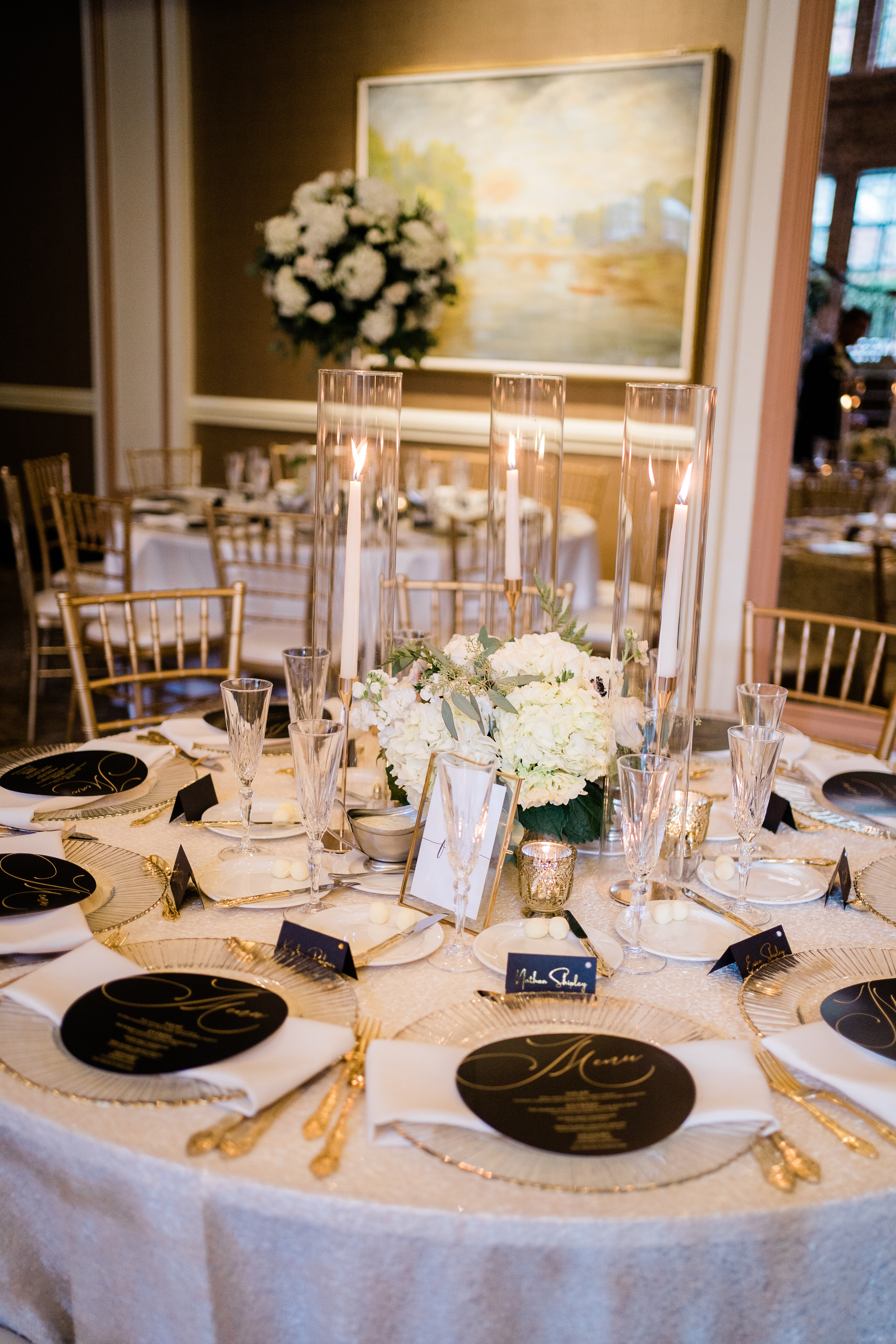 Fort Wayne wedding photographers photograph reception tables with gold accents and white florals