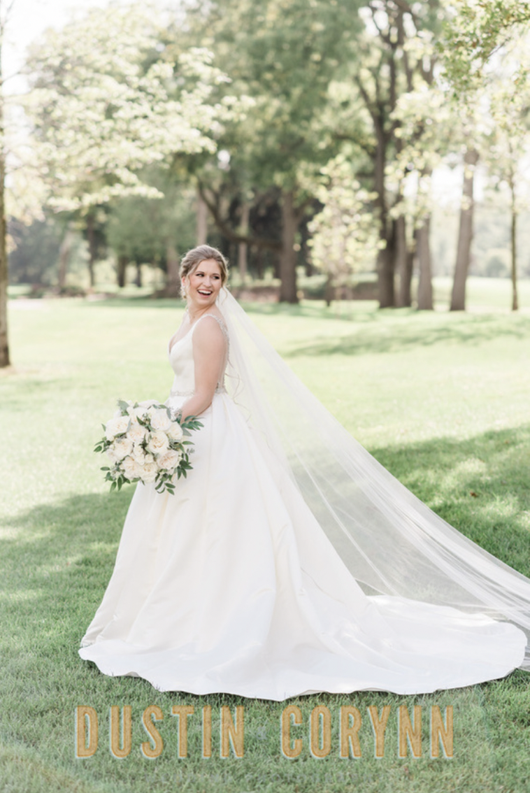 Fort Wayne wedding photographer captures bride looking over shoulder smiling during Sycamore Hills Golf Club bridals