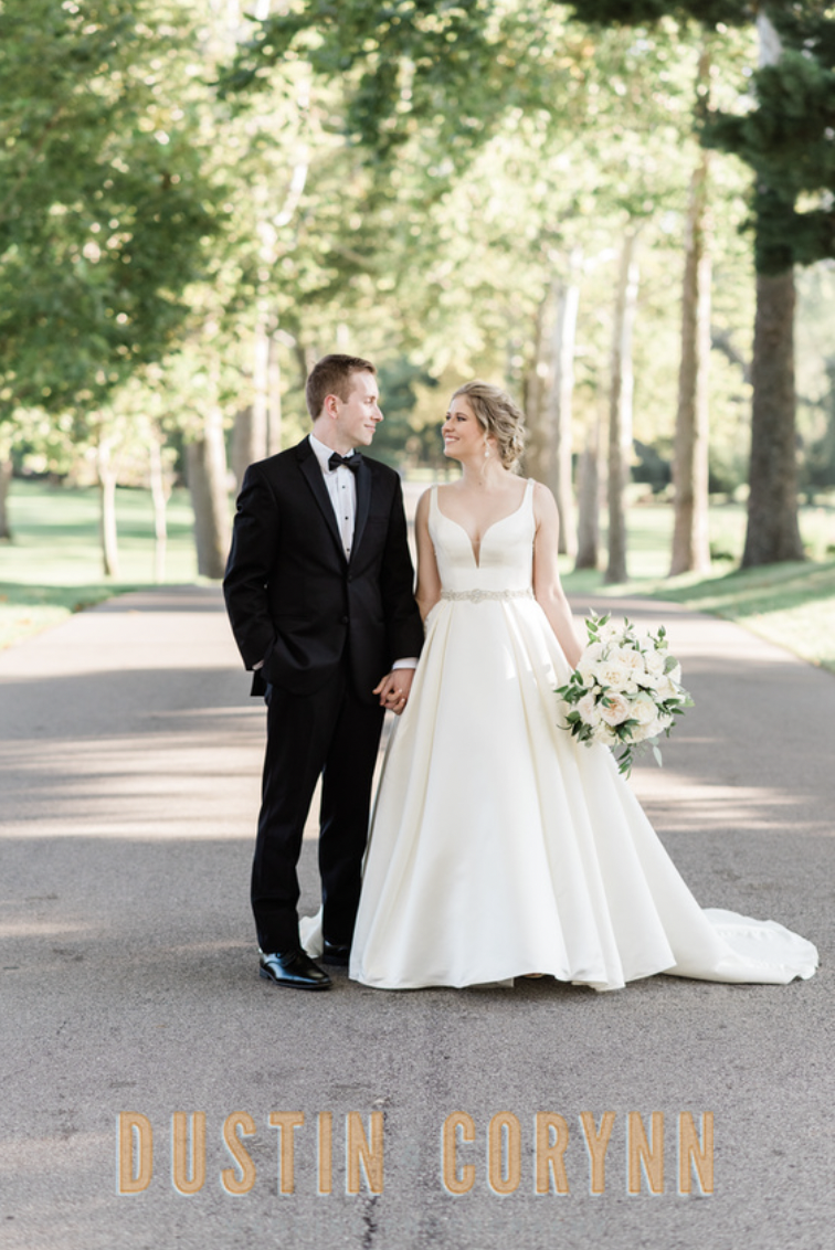 Fort Wayne wedding photographer captures bride and groom walking down path after Sycamore Hills Golf Club wedding ceremony