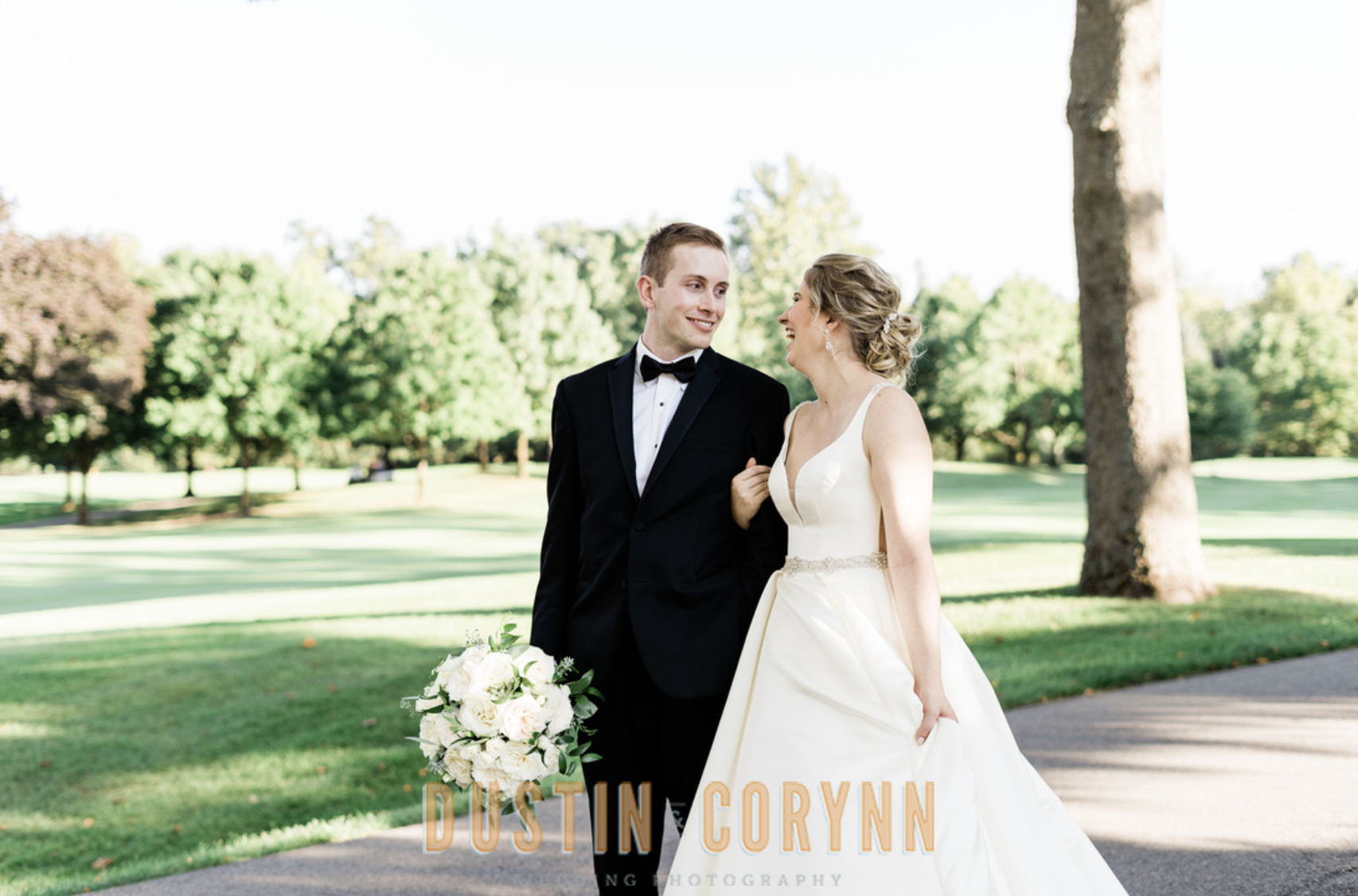 Fort Wayne wedding photographer captures bride and groom walking through golf course
