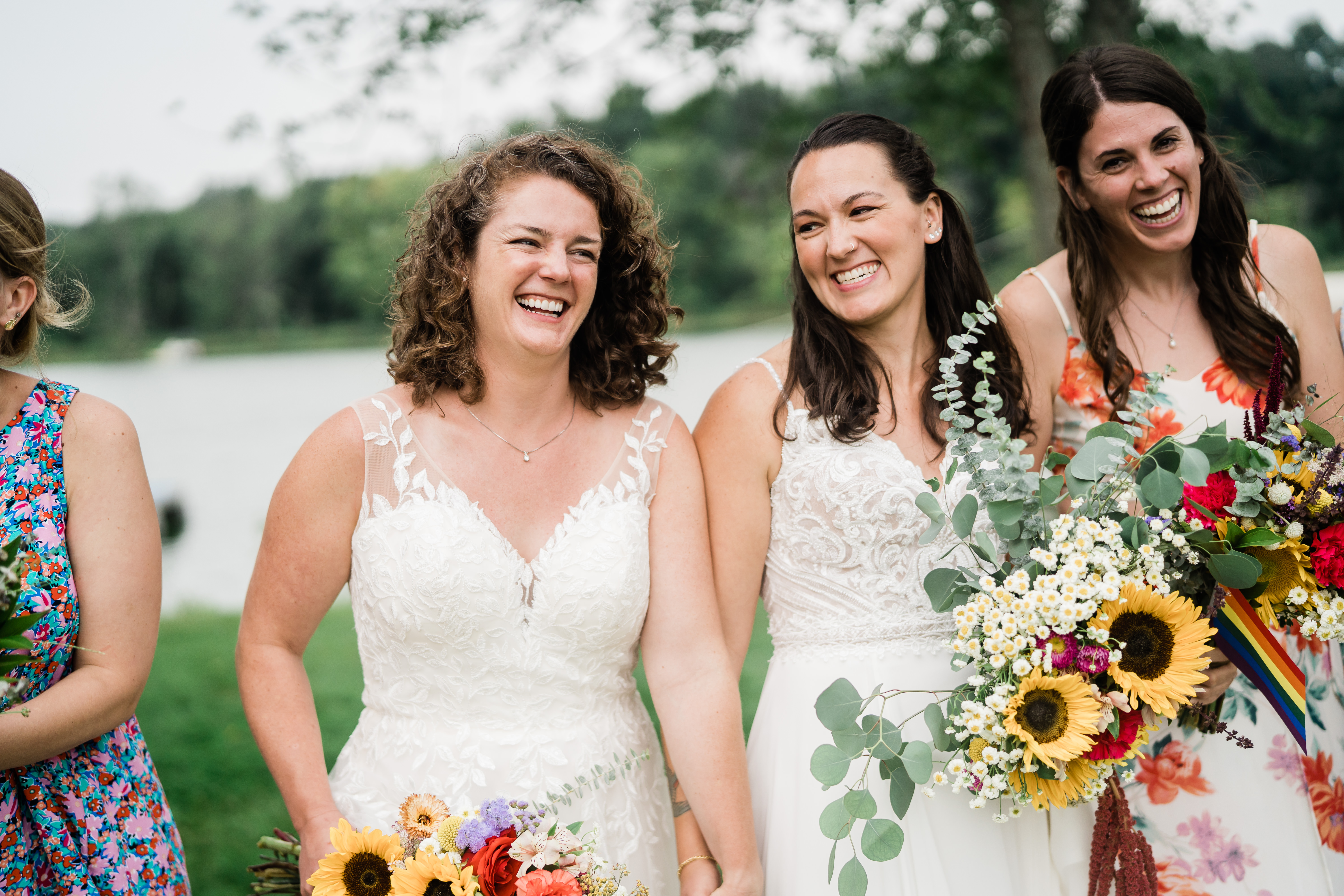 brides holding hands and laughing together