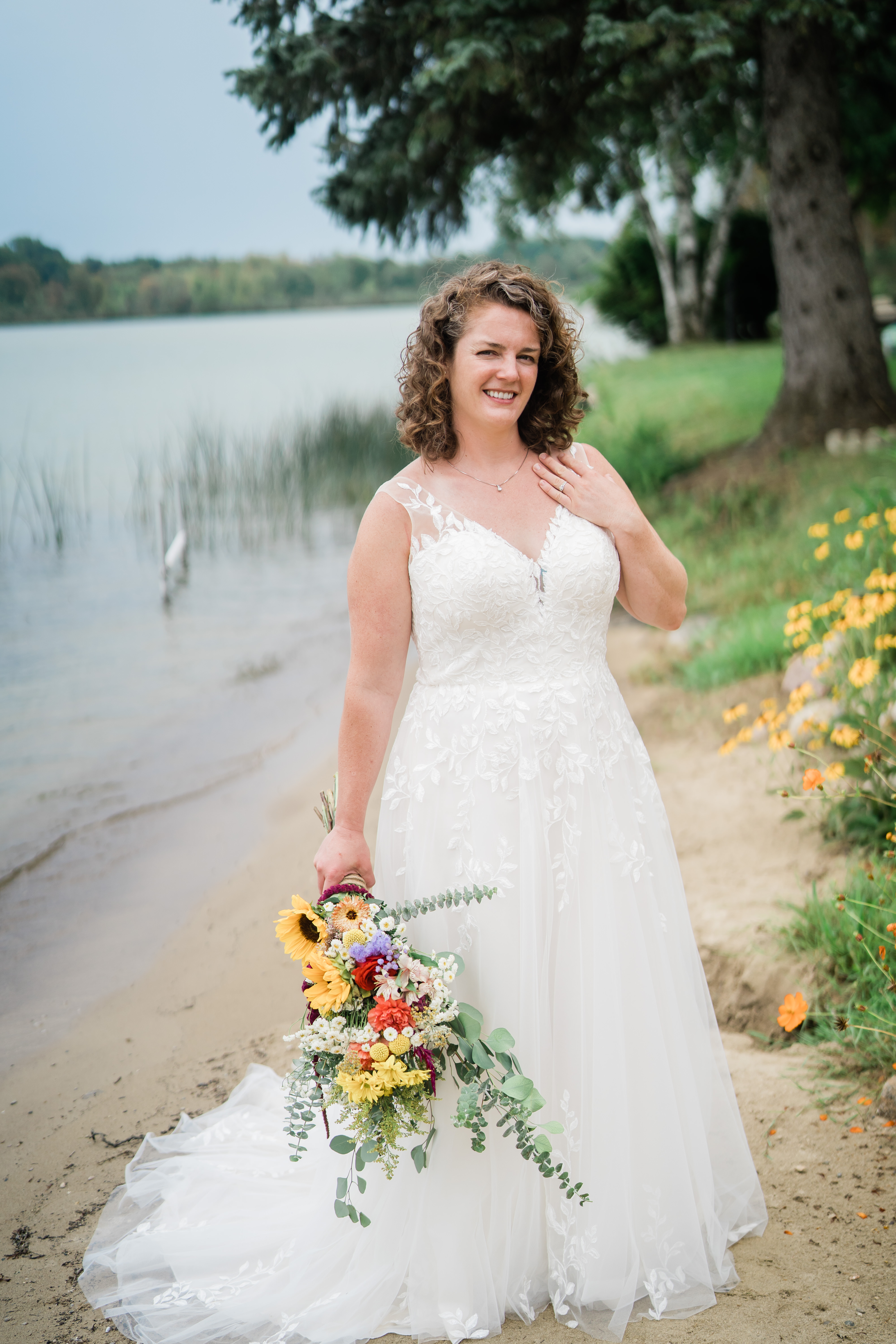 bride holding bridal bouquet by water