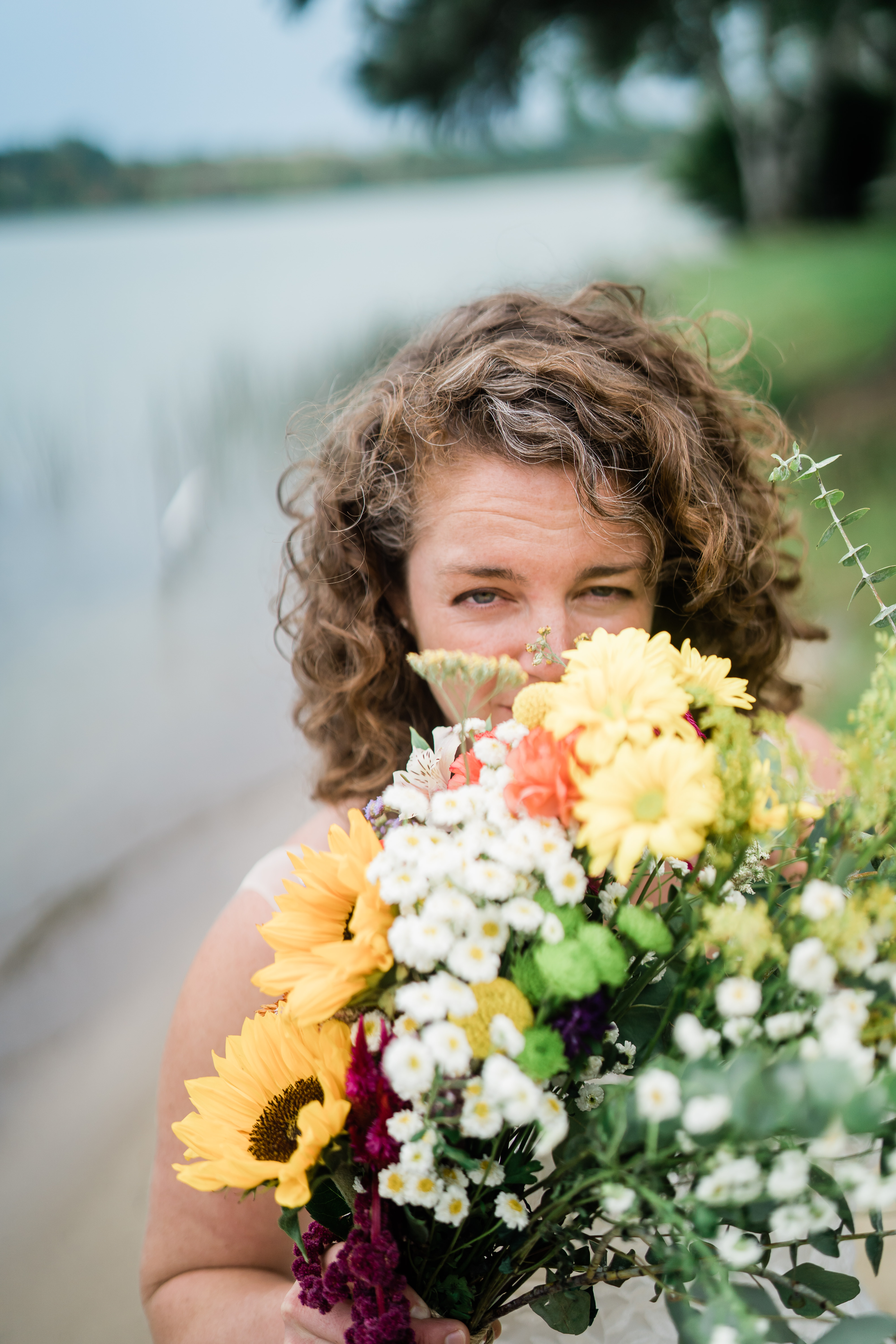 bride hiding behind bridal bouquet