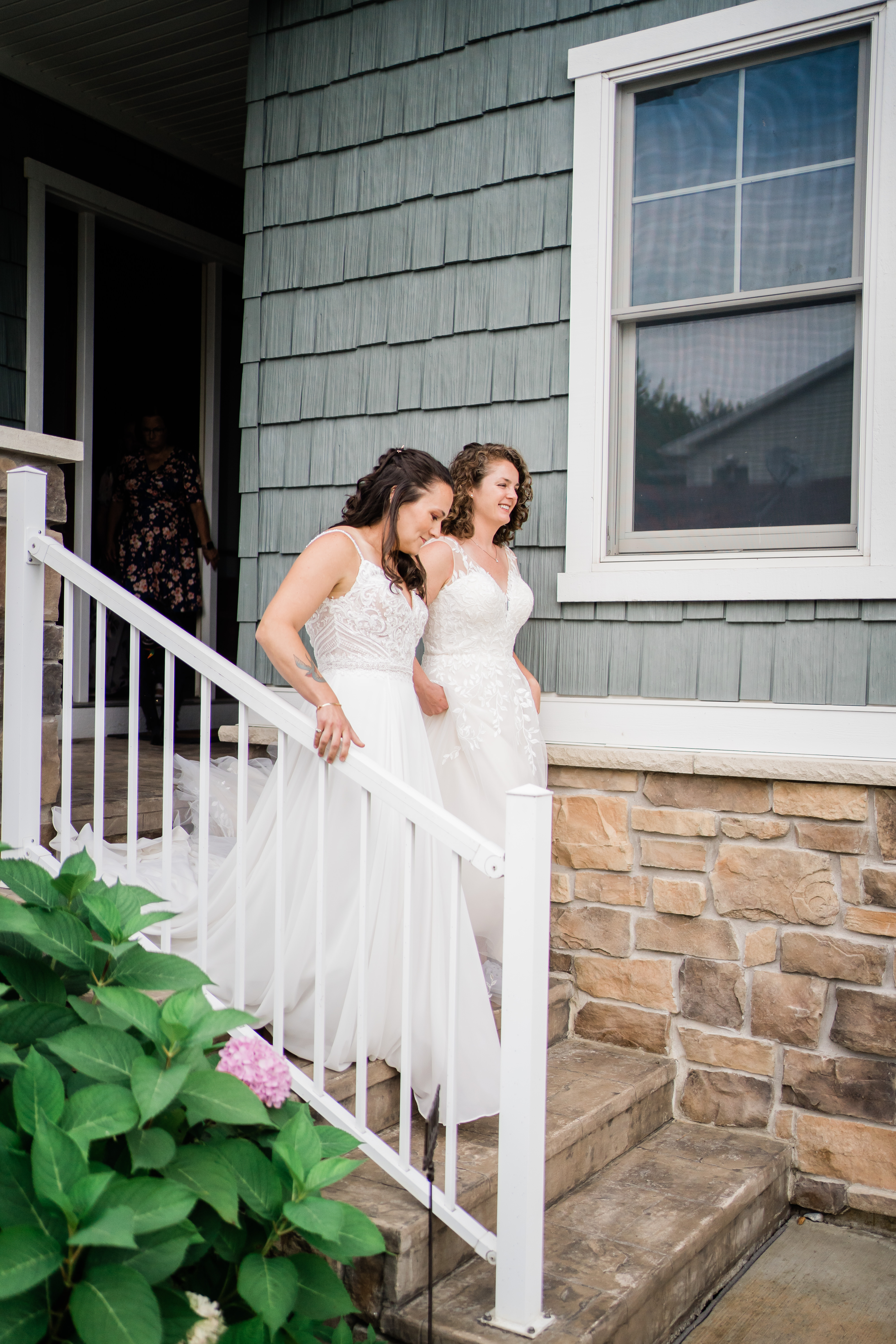 brides walking down steps together before first look with fathers