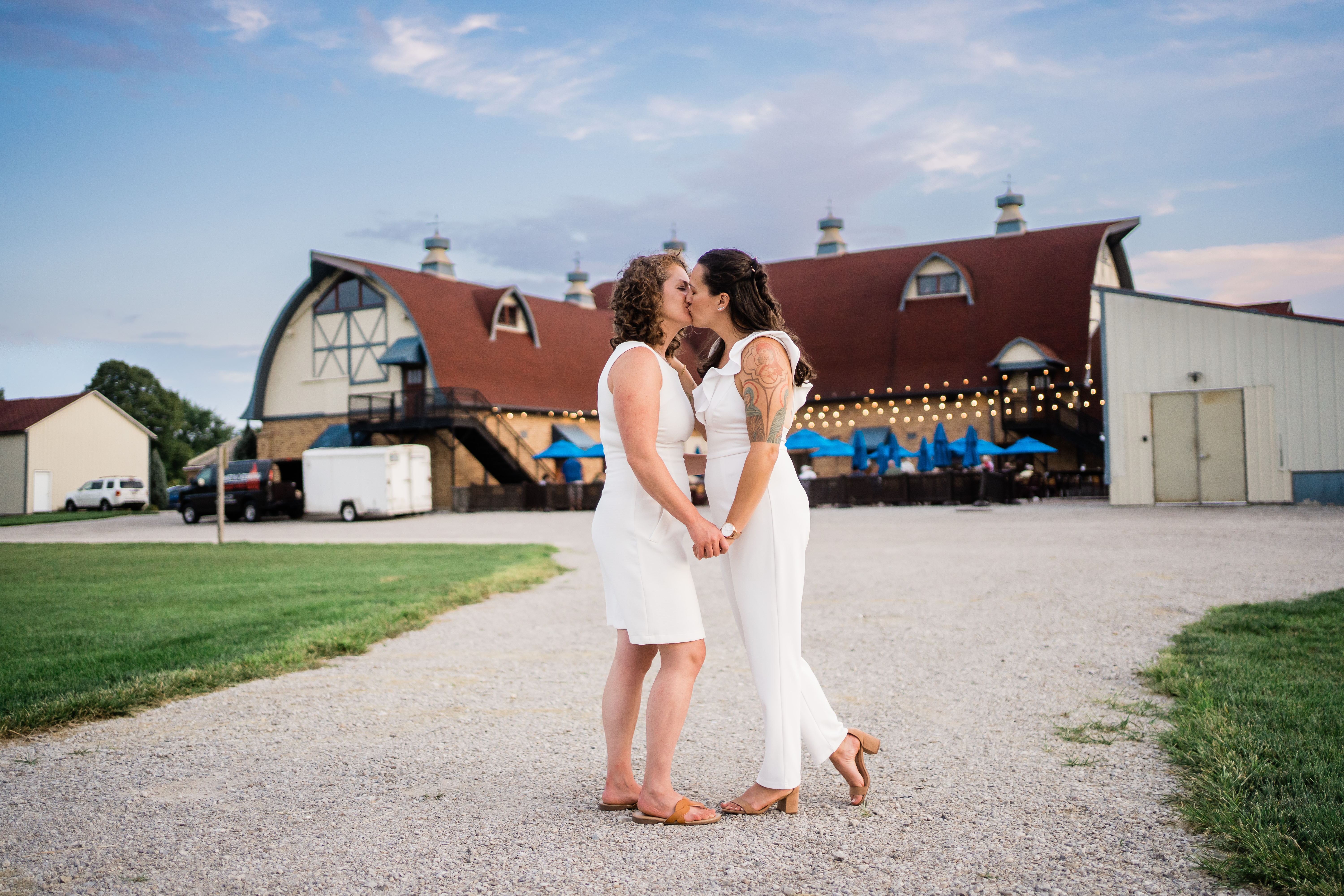 couple kissing outside modern sylvan cellars wedding reception