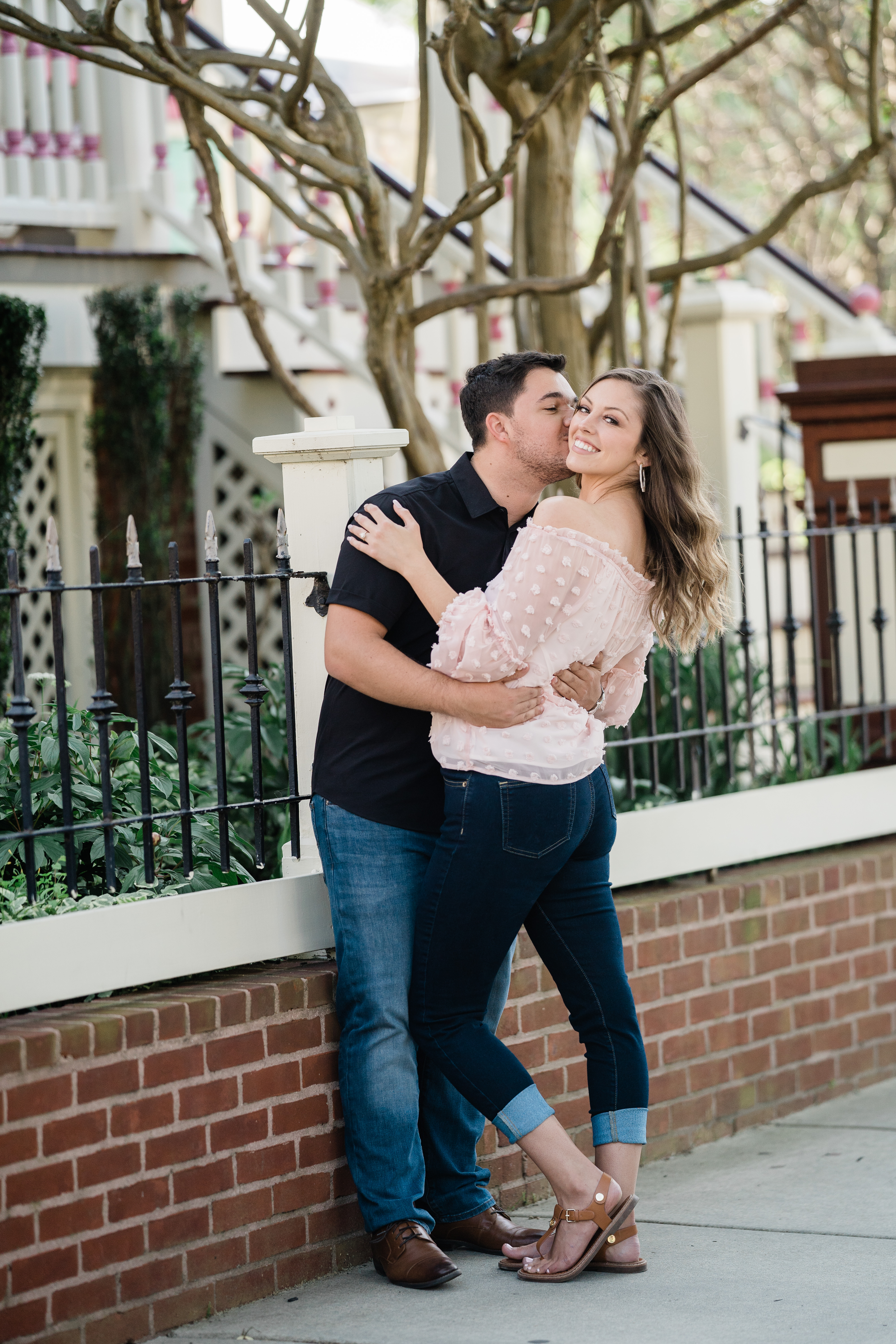 Fort Wayne wedding photographer captures man kissing woman's cheek during engagements after surprise proposal
