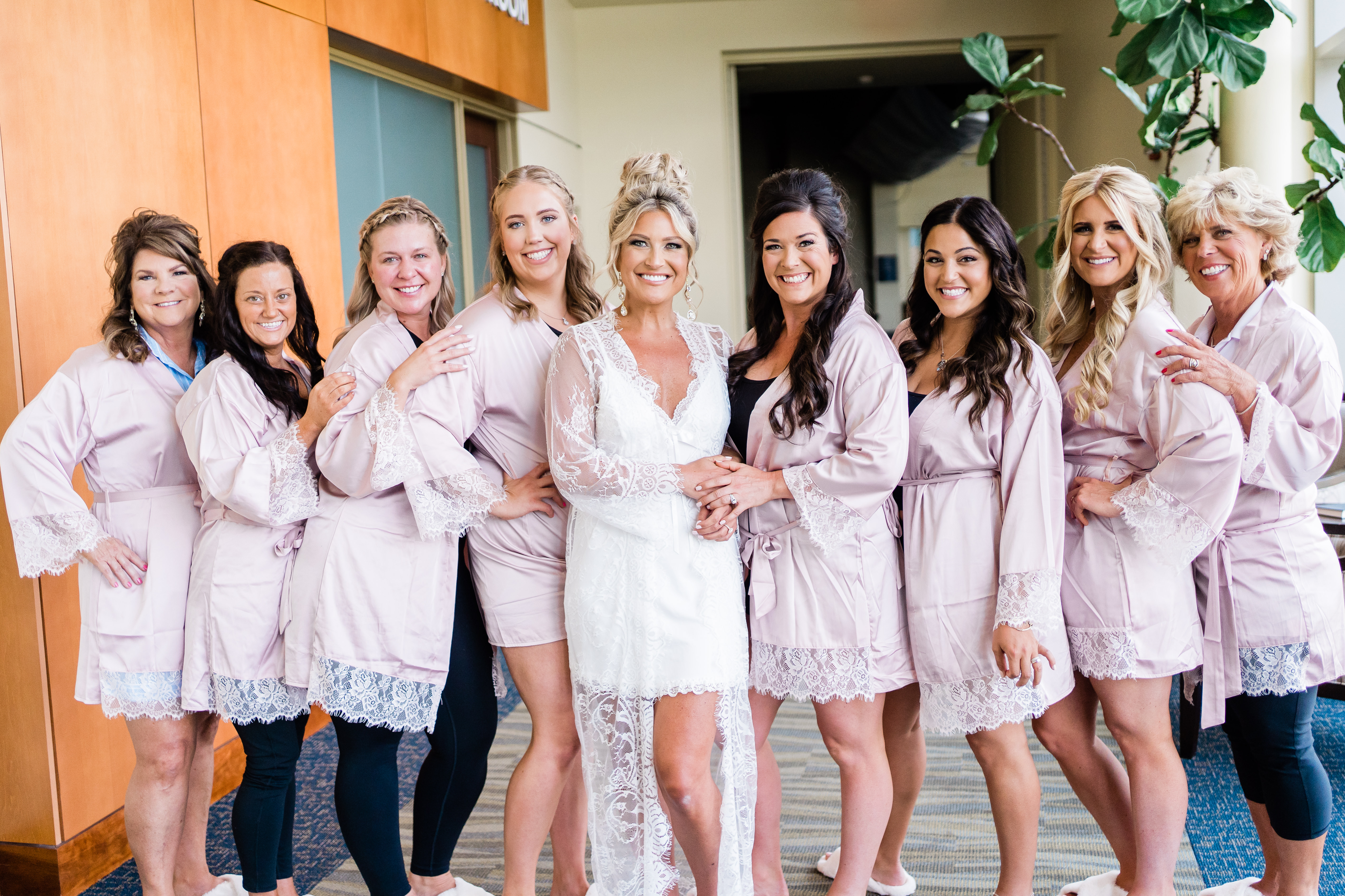 Indiana wedding photographer captures bride standing with bridesmaids wearing robes