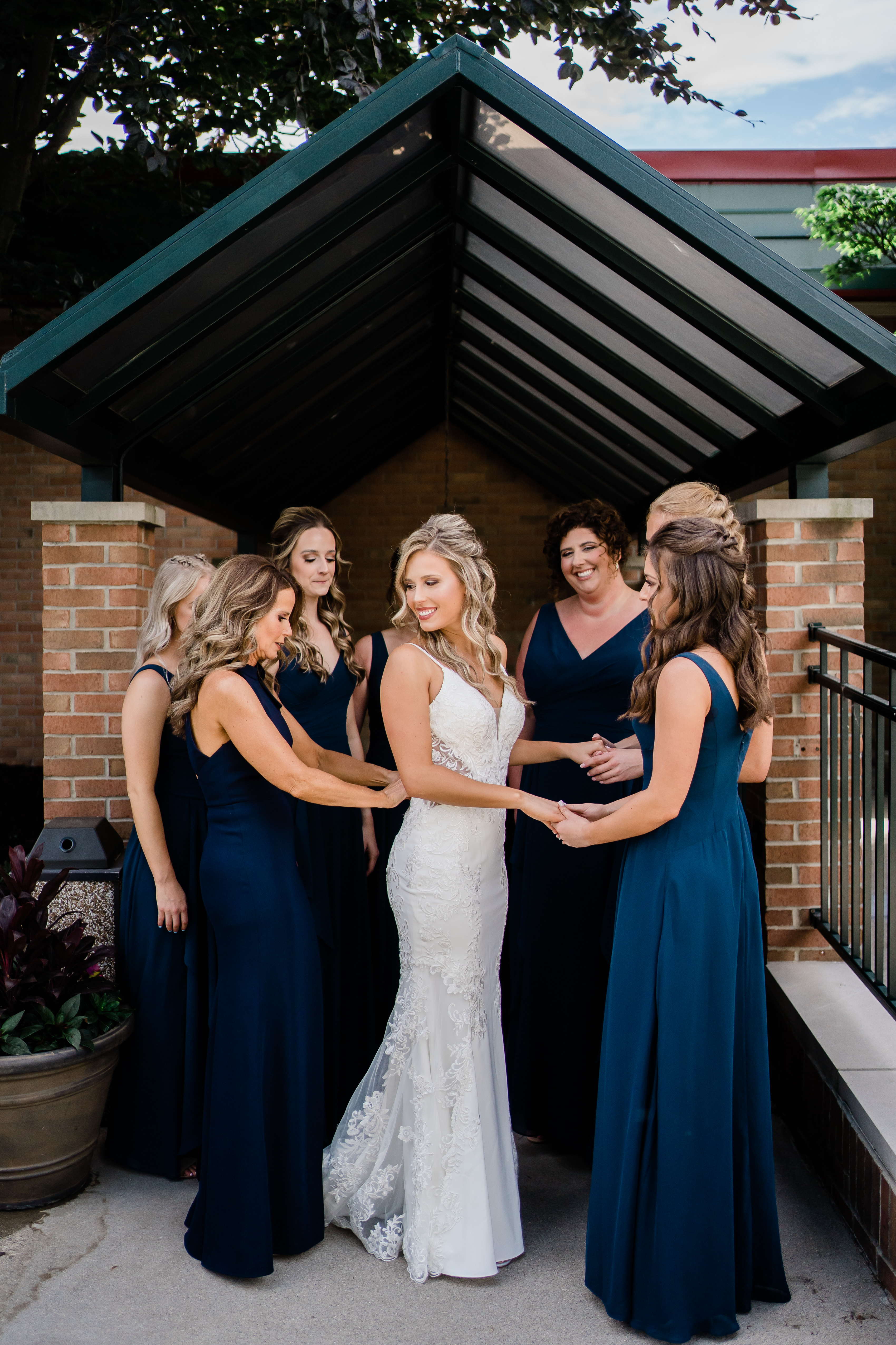 Fort Wayne wedding photographers capture bride standing with bridesmaids