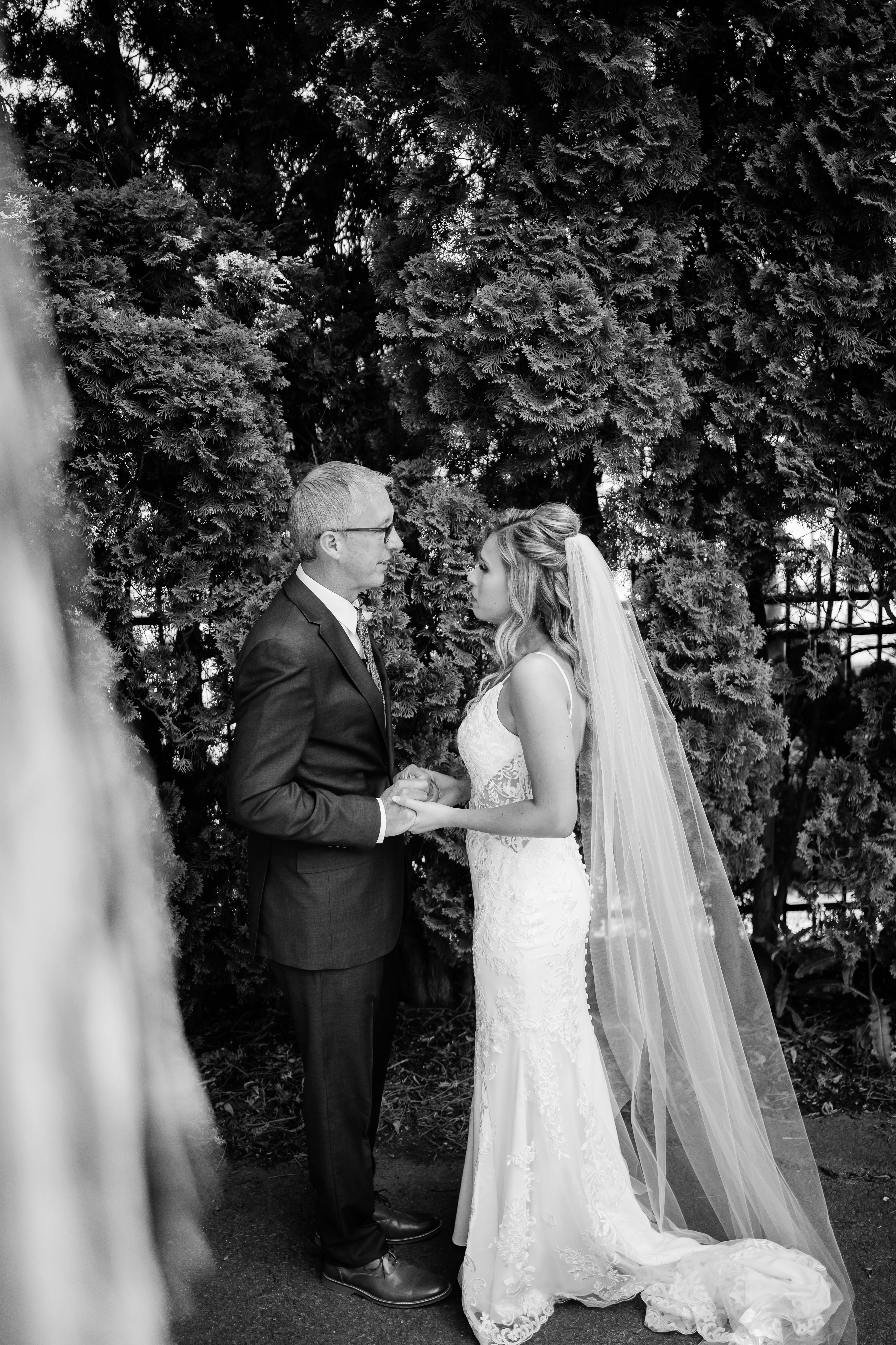 bride and father holding hands and smiling before stunning country club wedding