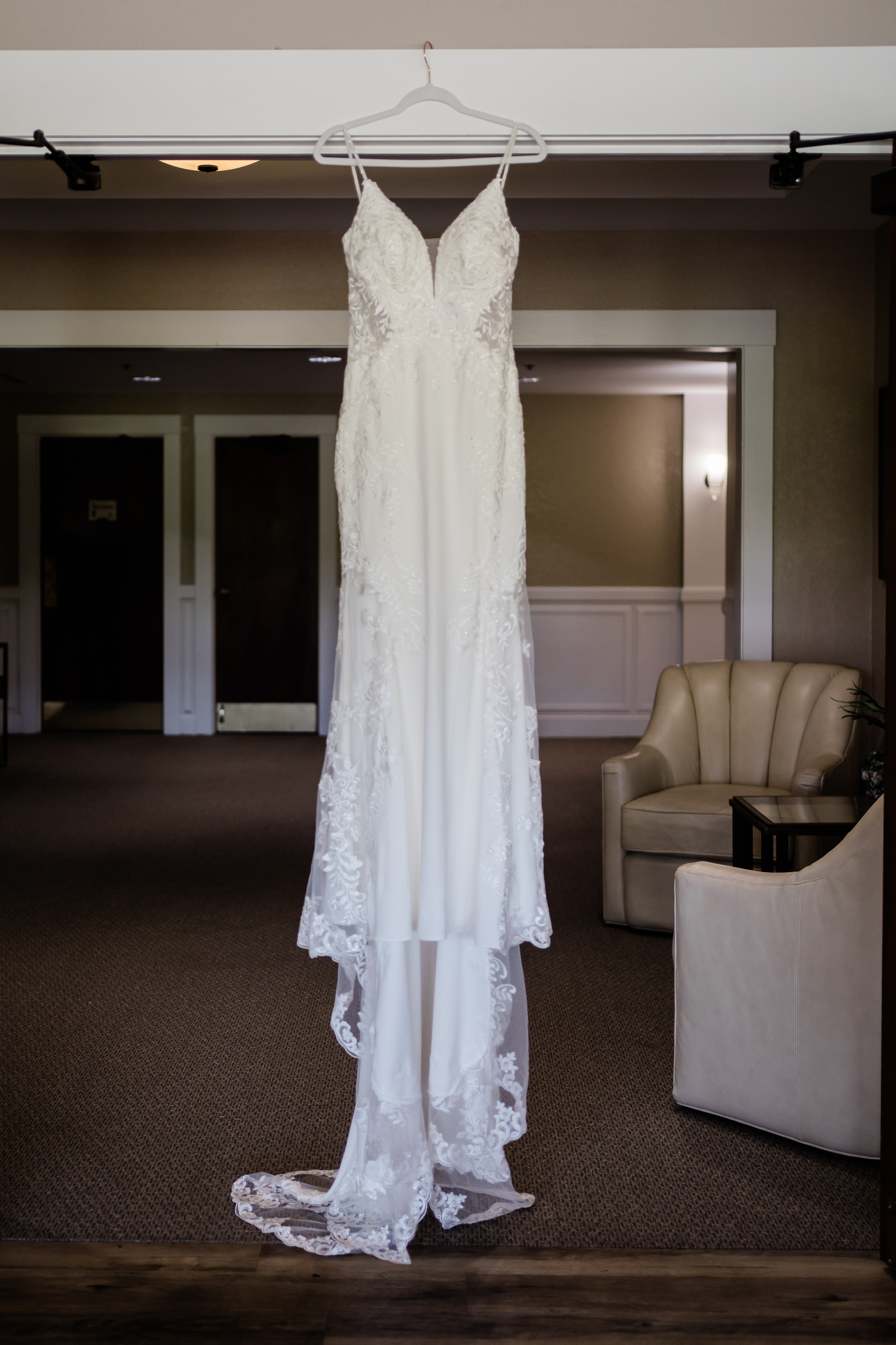 Fort Wayne wedding photographers capture wedding dress hanging before bride gets dressed