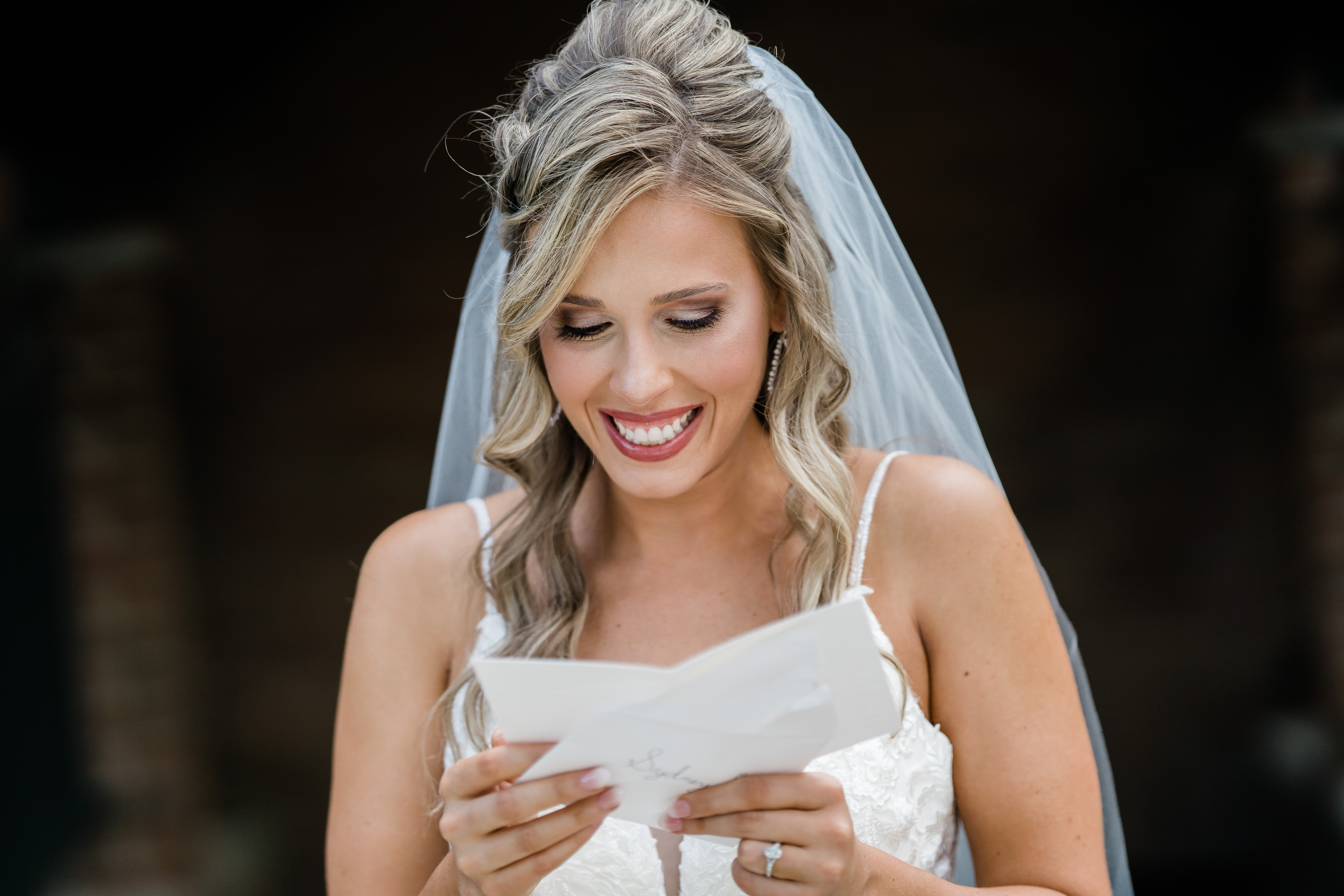 Fort wayne wedding photographers capture bride smiling reading letter