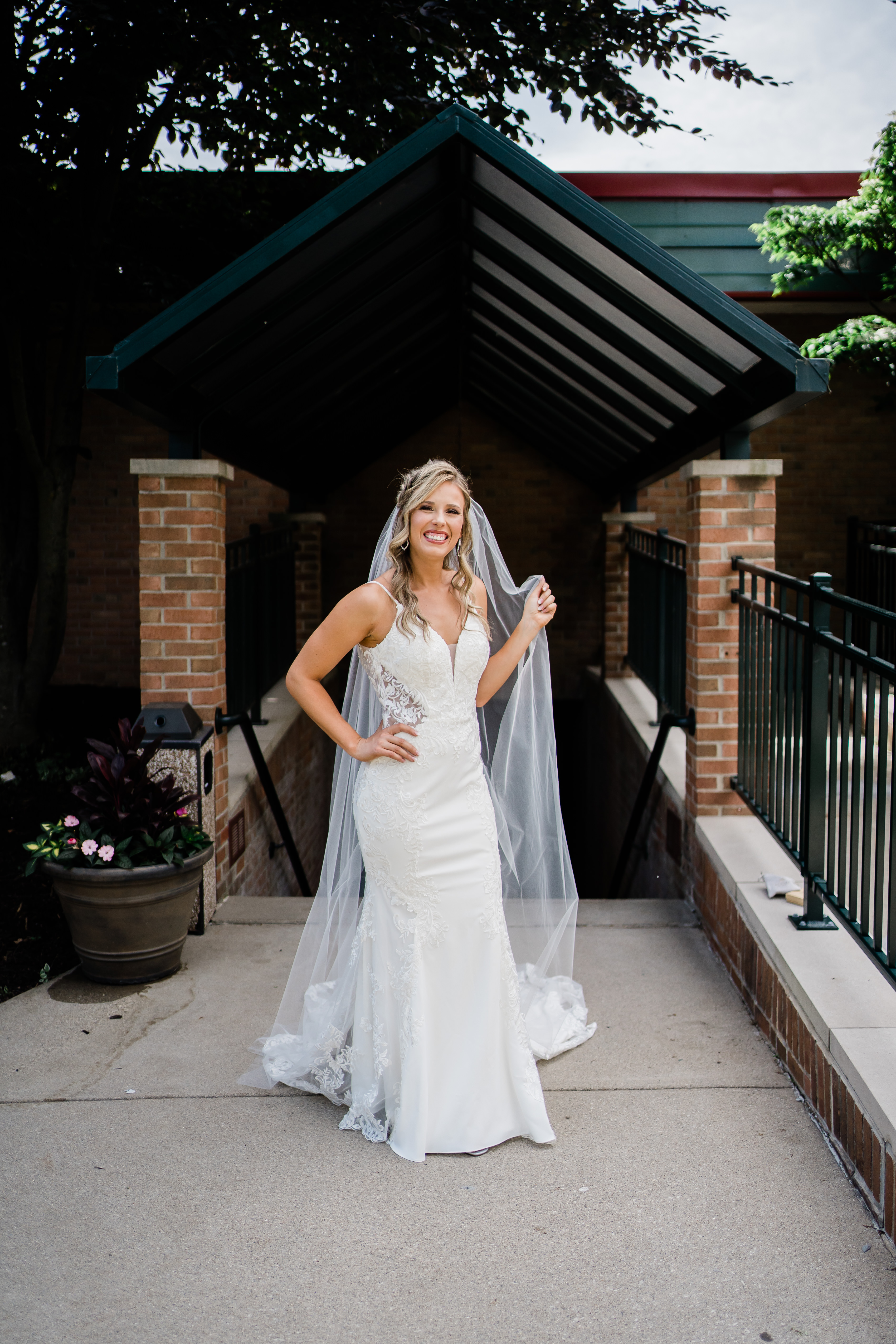 Fort Wayne wedding photographers capture bride standing and smiling during portraits before stunning country club wedding