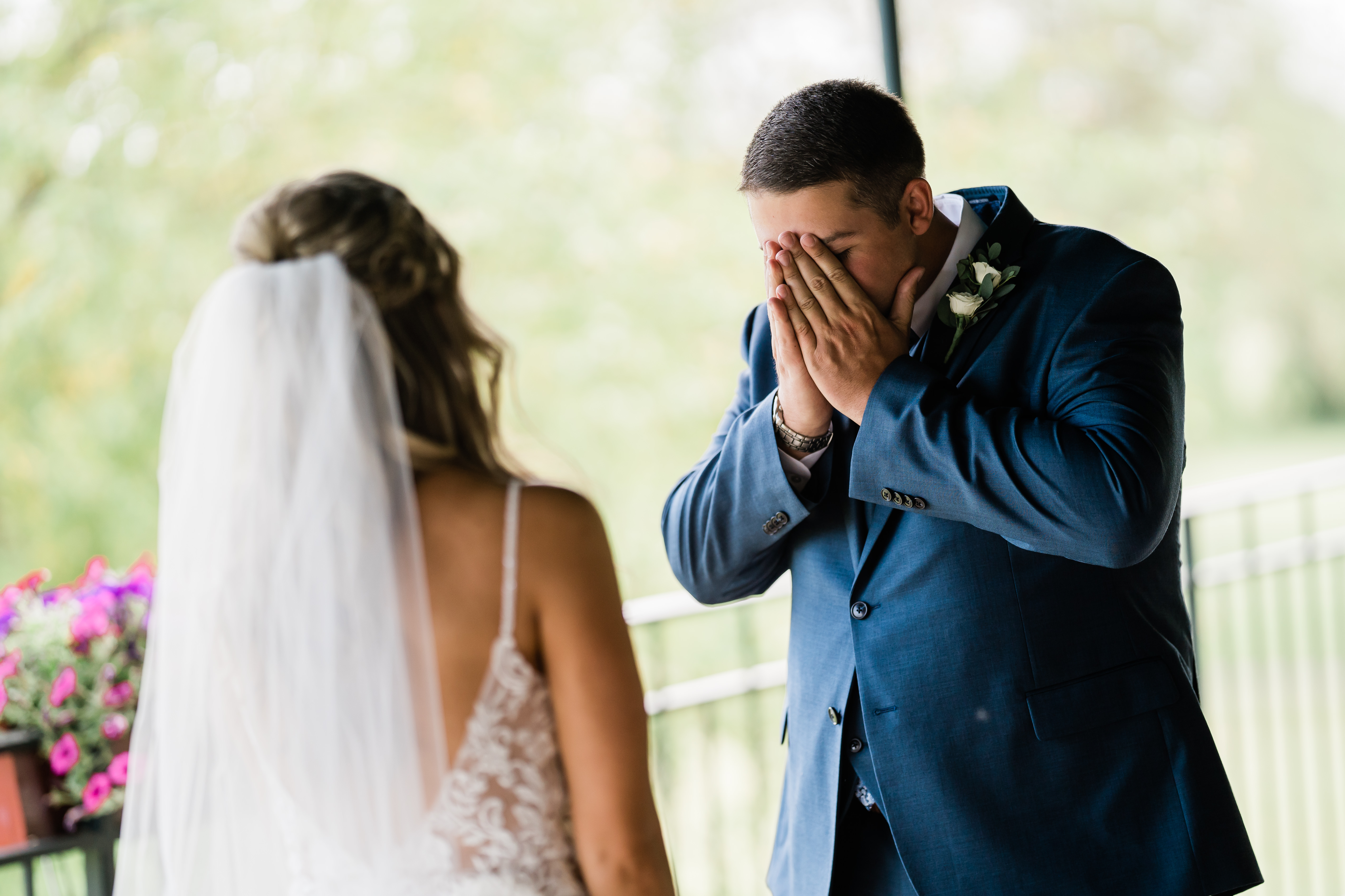 Fort Wayne wedding photographers capture groom covering face after seeing bride for first time