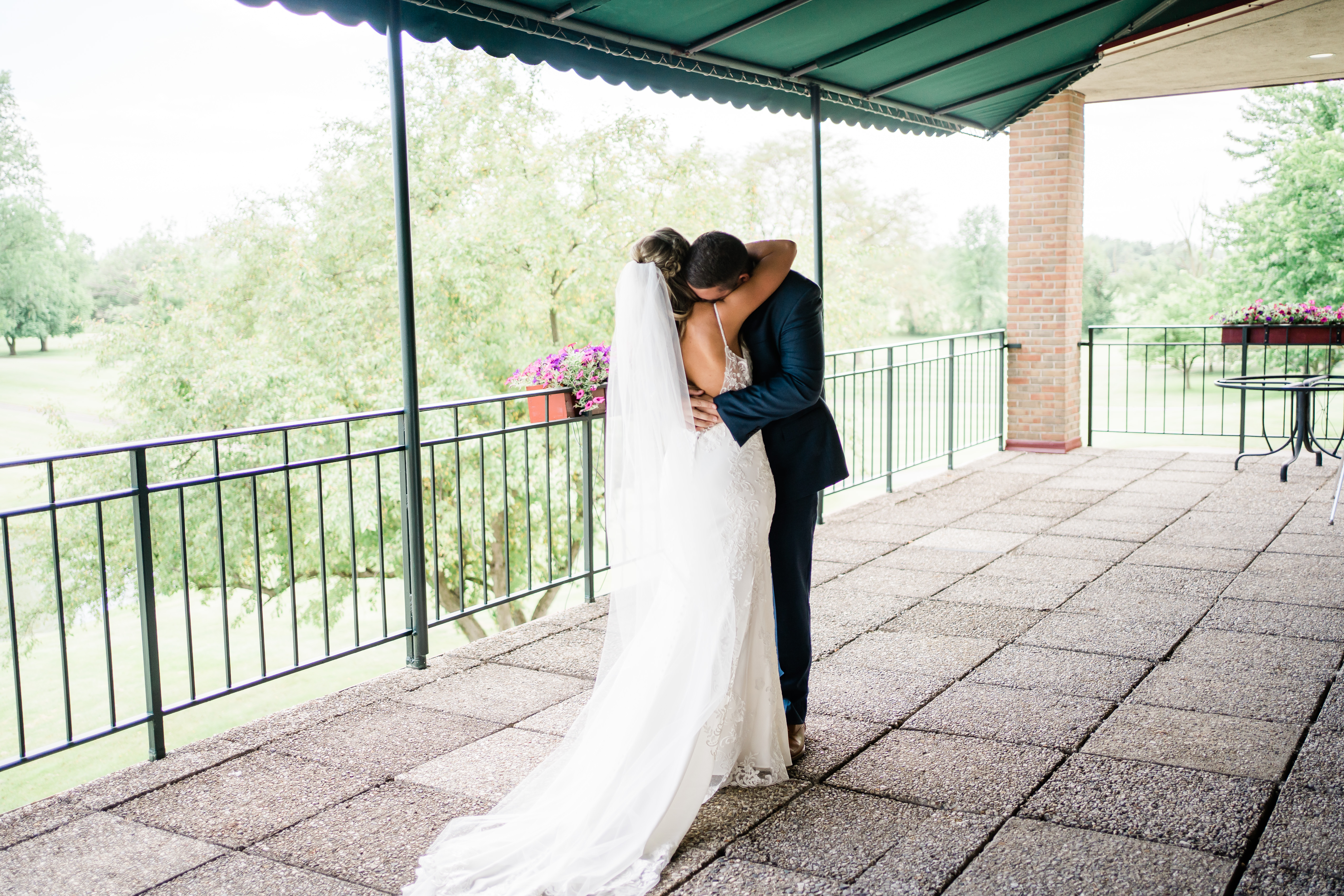 Fort Wayne wedding photographers captures bridal couple hugging