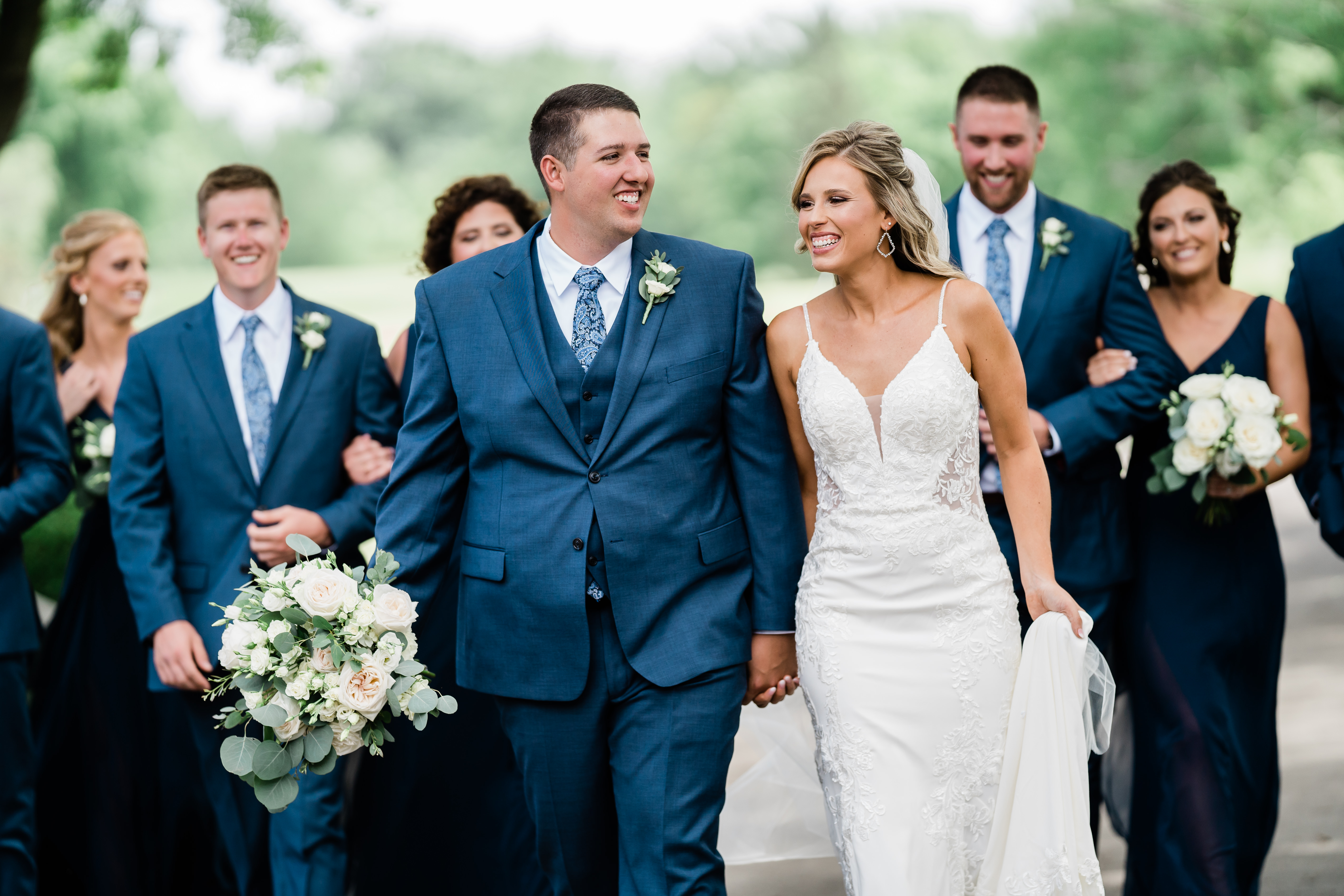 Fort Wayne wedding photographers capture bride and groom walking together on wedding day after they choose fort wayne wedding photographers