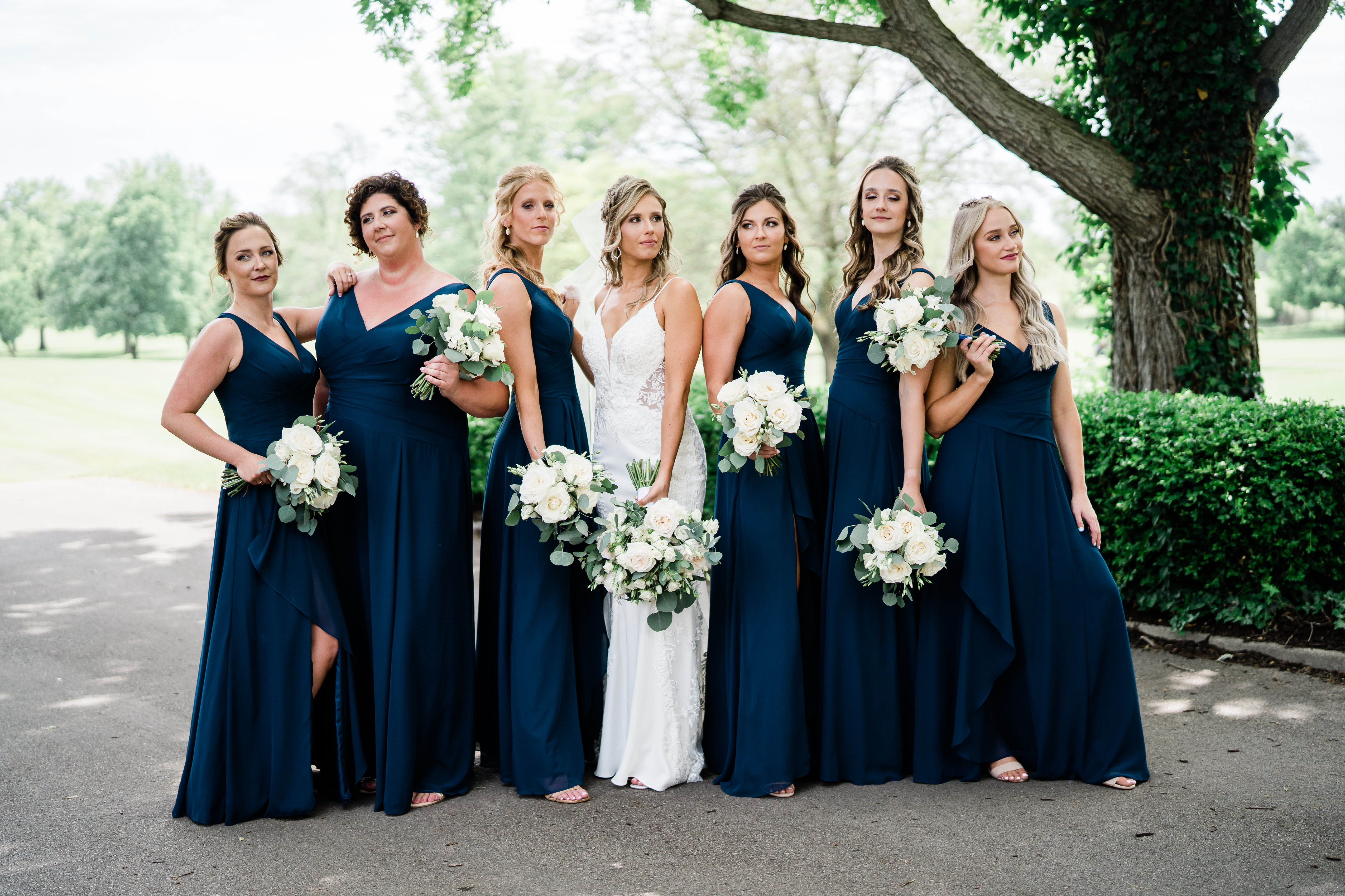 Fort Wayne wedding photographers capture bride with bridesmaids holding bouquets