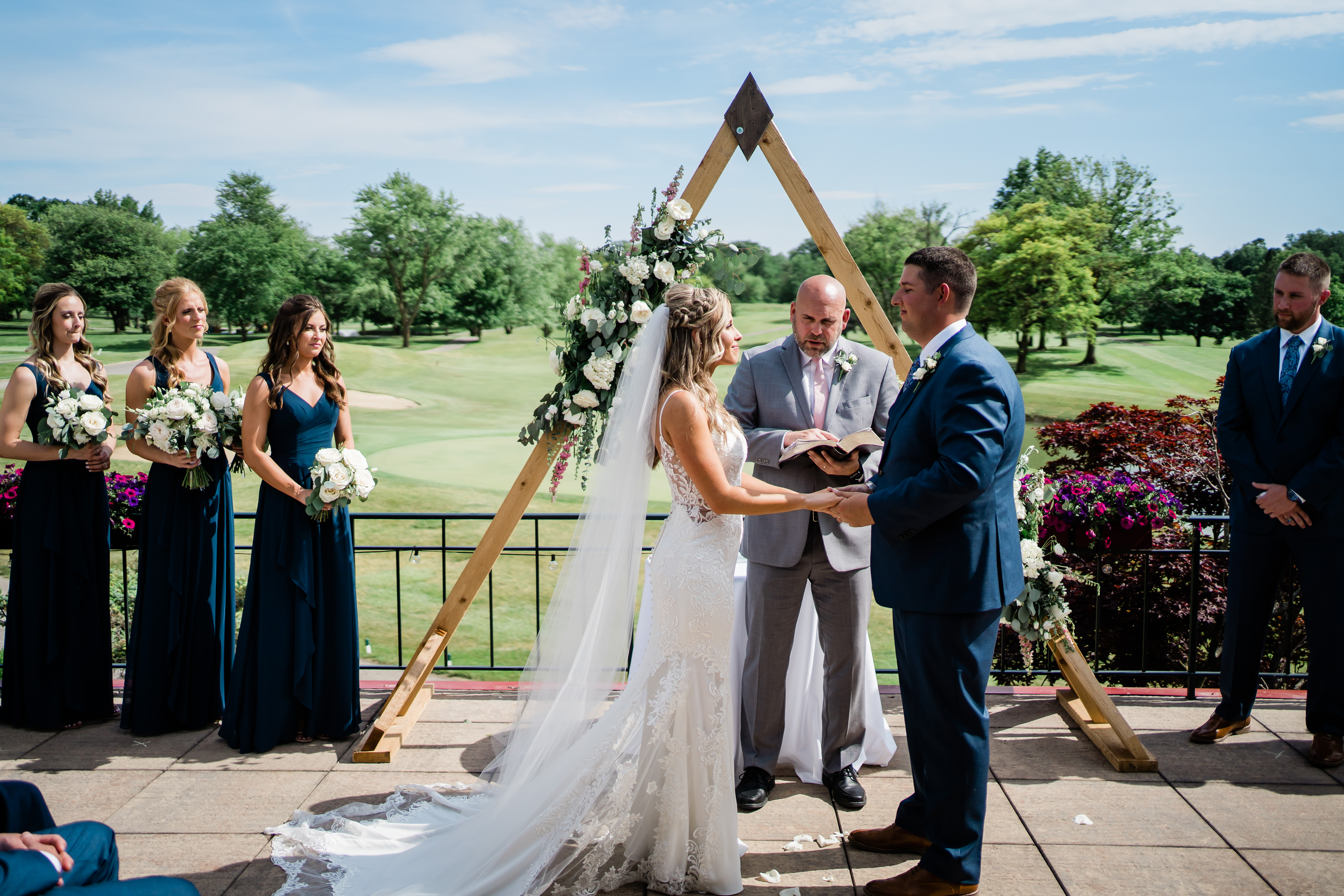 Fort Wayne wedding photographers capture bride and groom at alter before stunning country club wedding