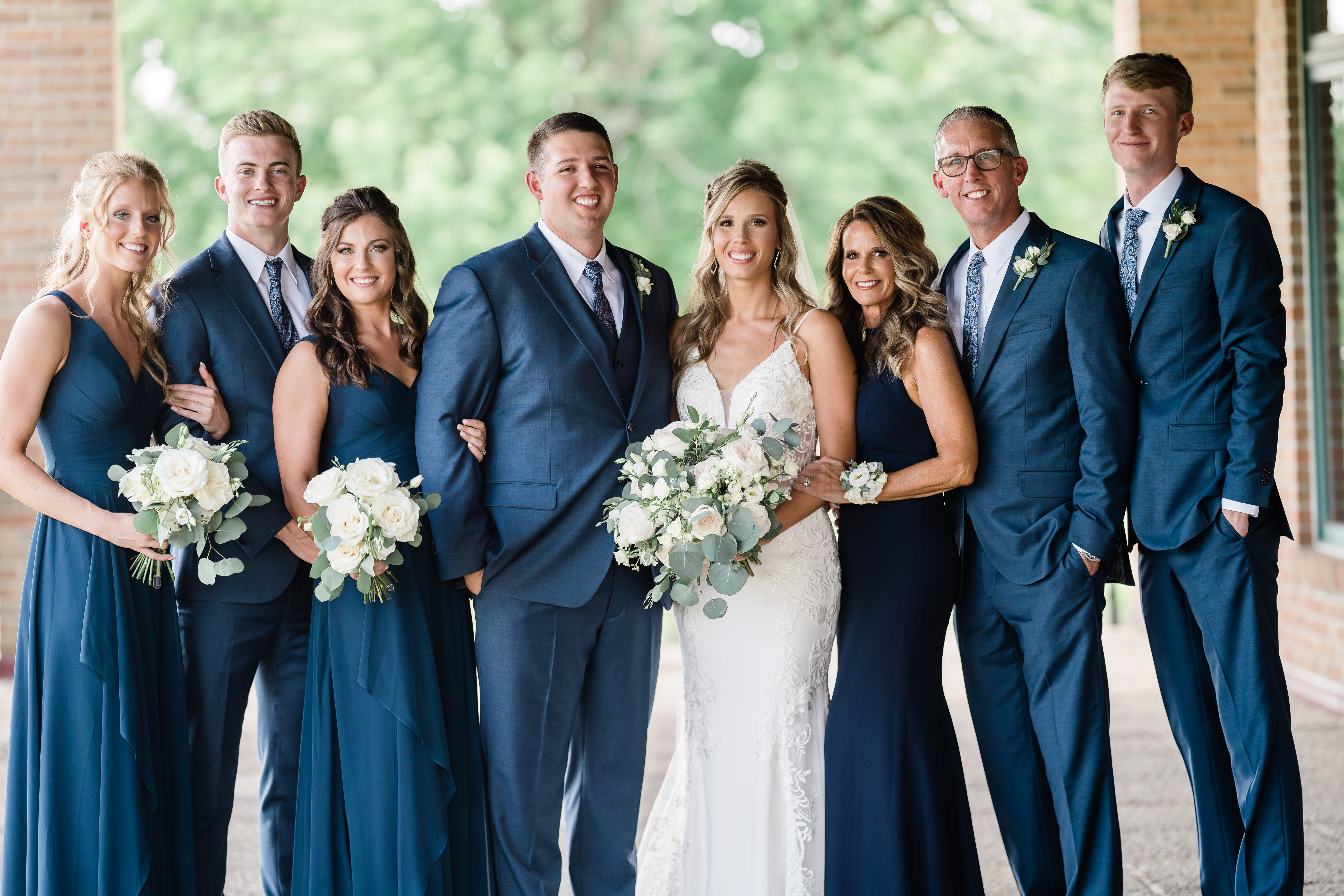 Fort wayne wedding photographers capture bride and groom standing with family after ceremony