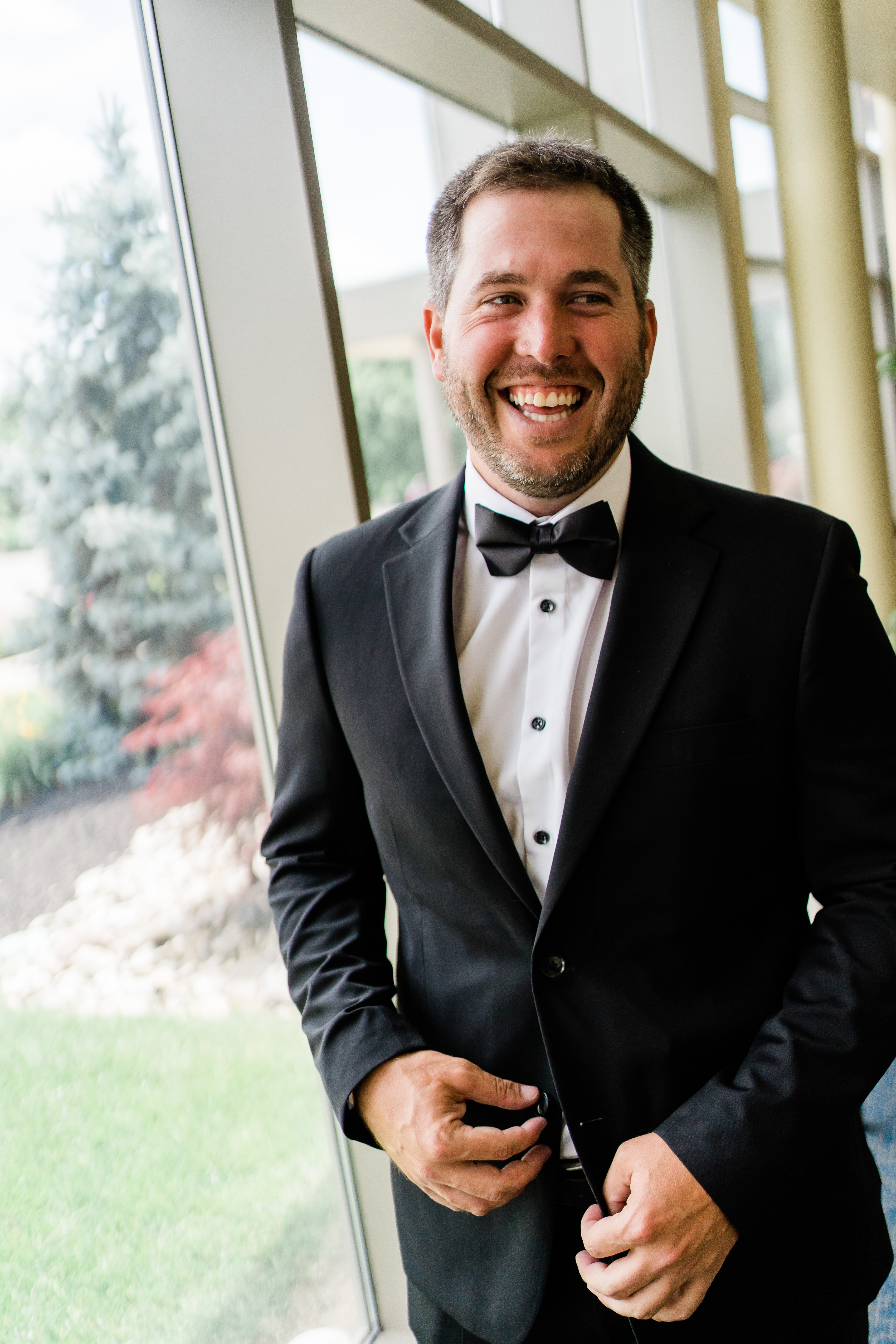 Indiana wedding photographer captures groom smiling while getting ready