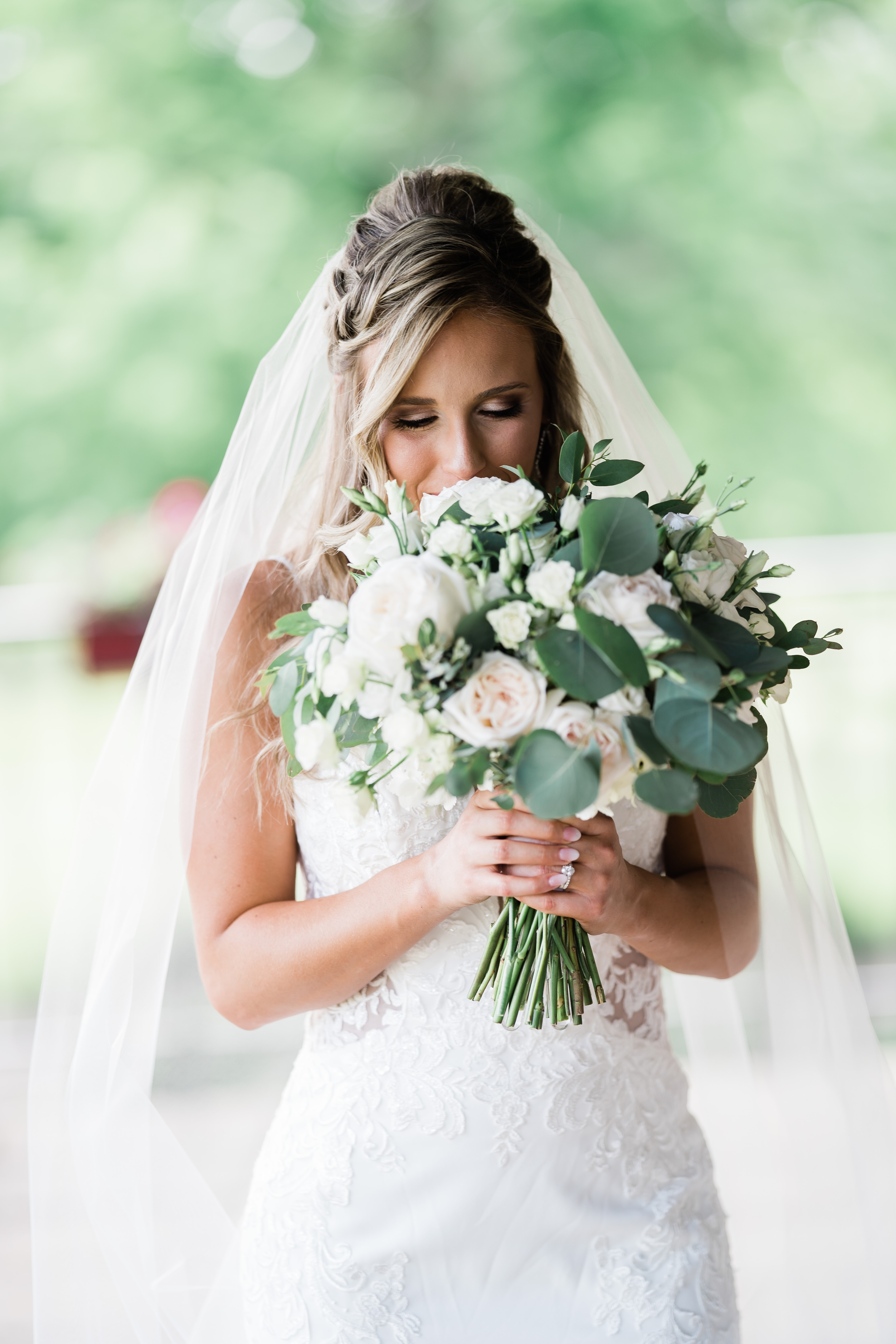 bride smelling bouquet during portraits