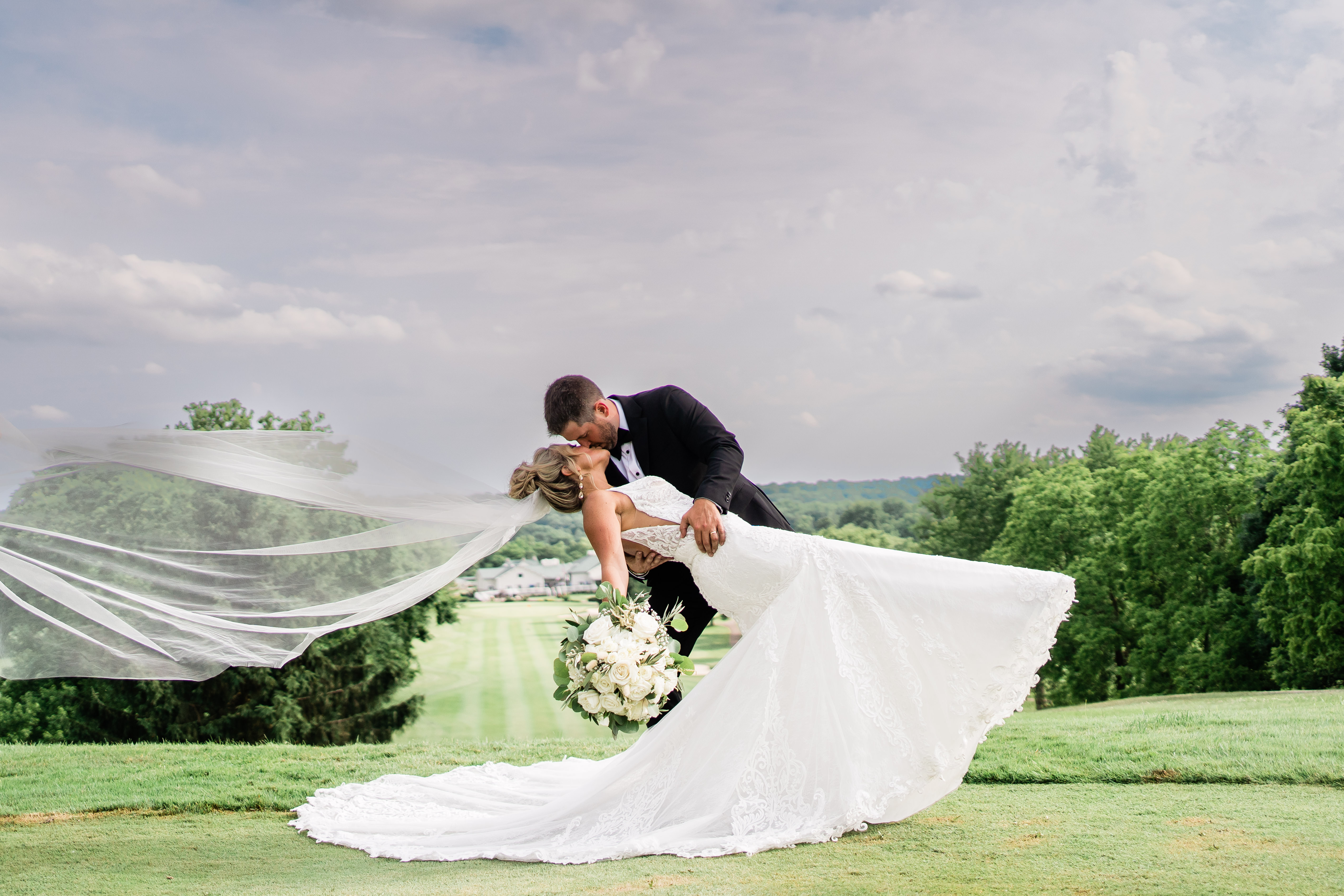 bride and groom dip kissing in ohio golf course wedding