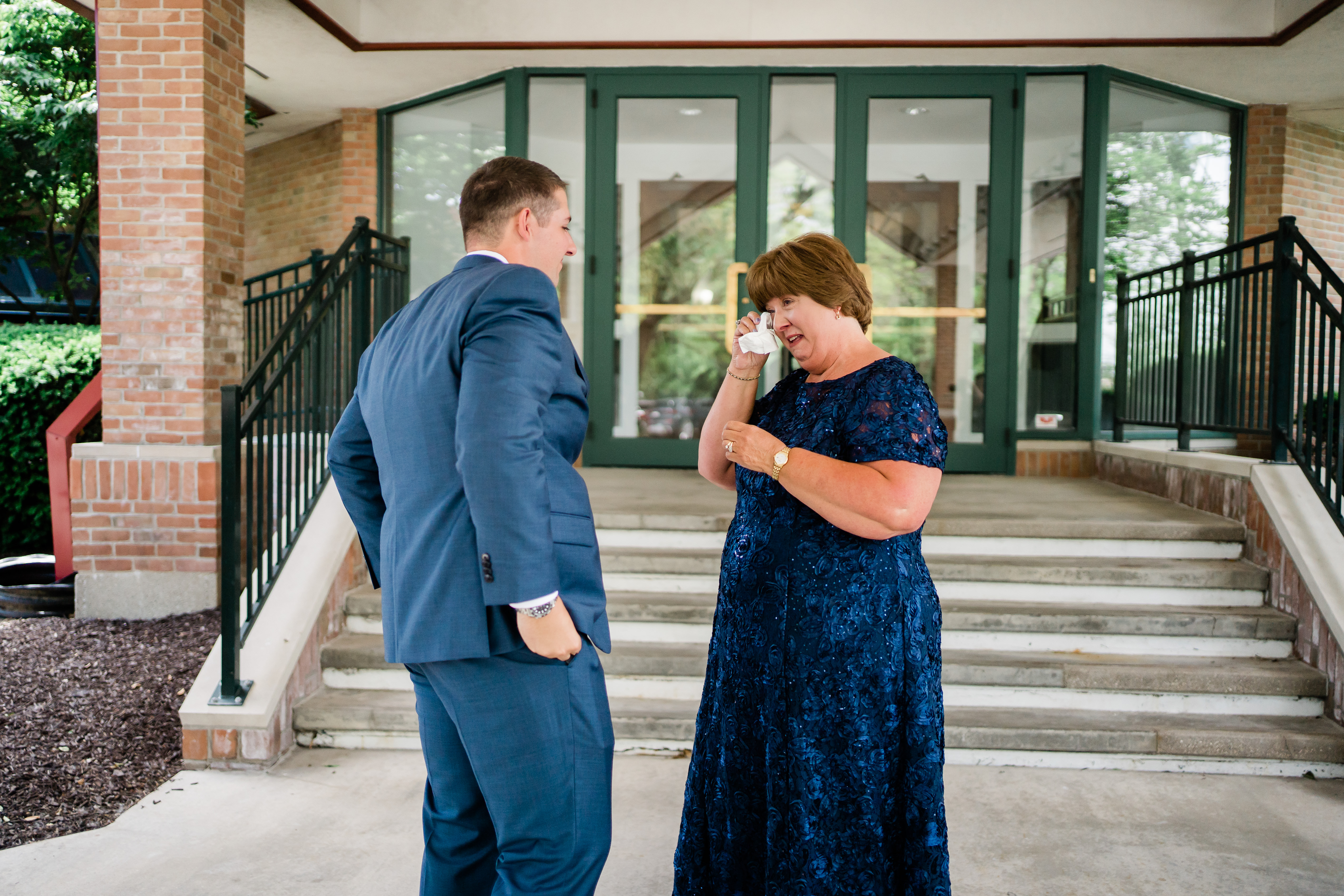 Fort Wayne wedding photographers capture groom's mother crying seeing groom for first time