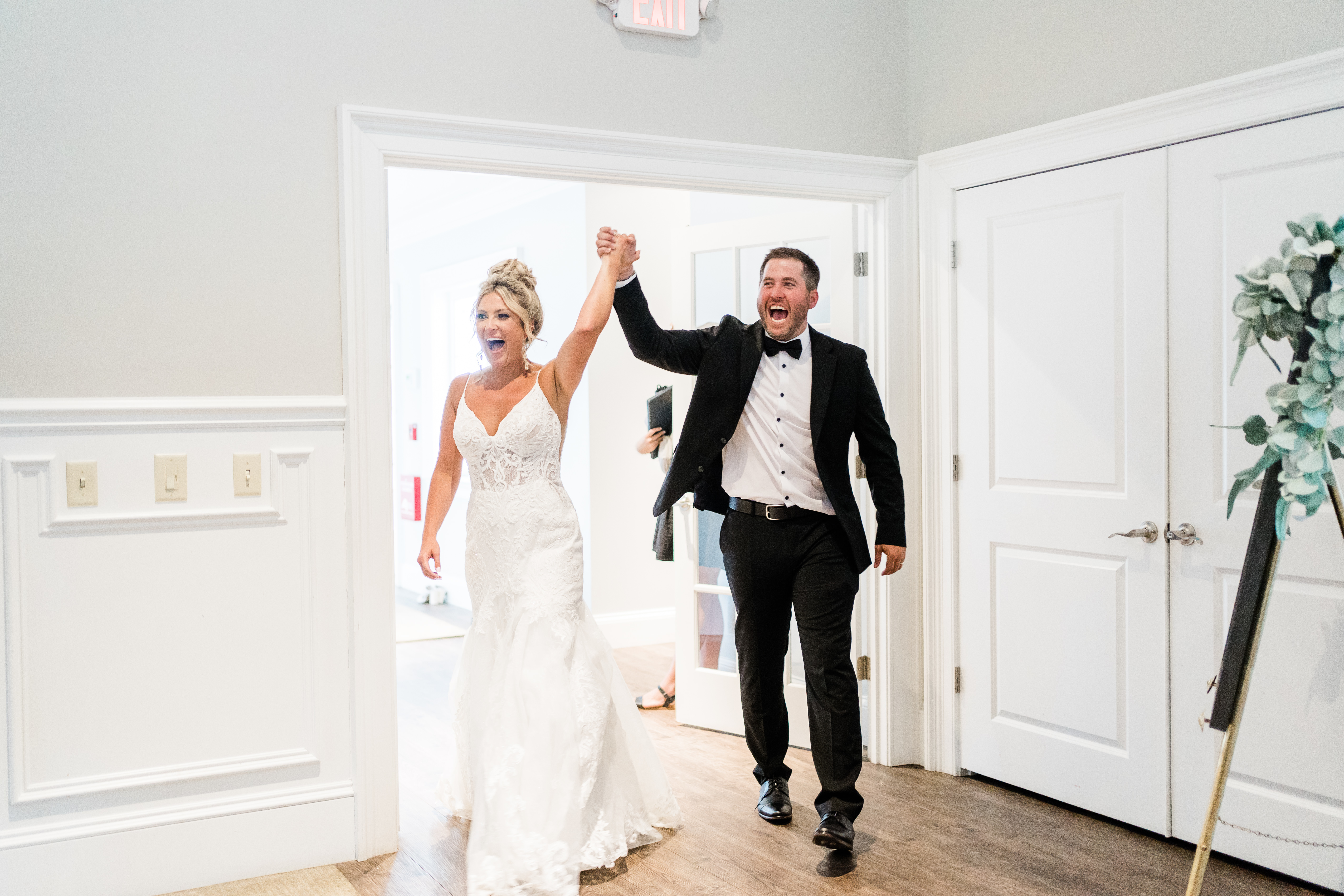 Fort wayne wedding photographers capture bride and groom walking into reception